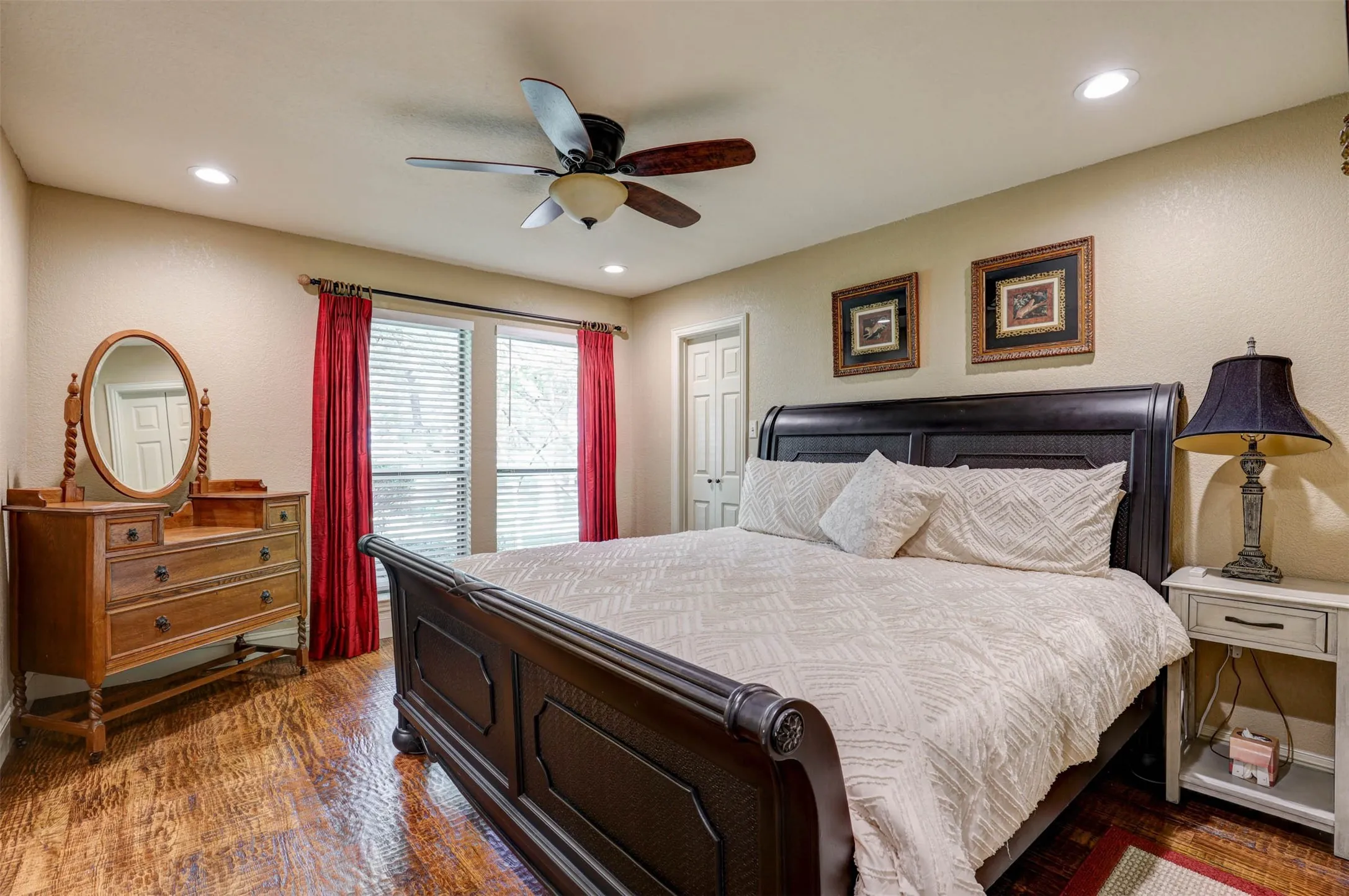 Generous secondary bedroom with ceiling fan and walk in closet.