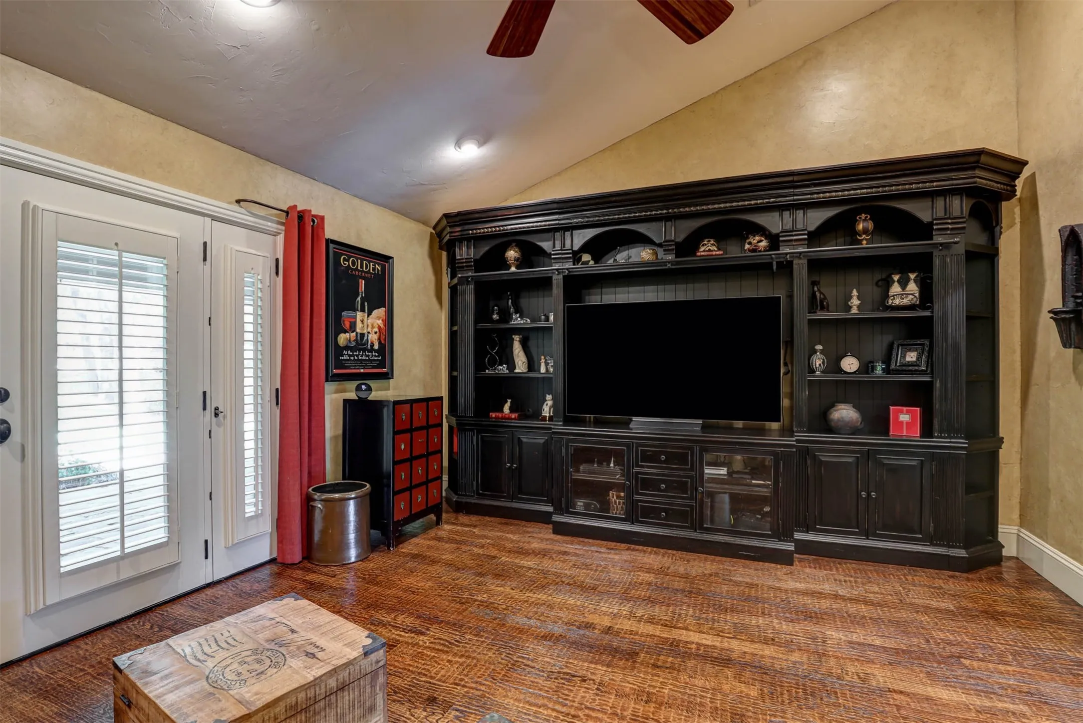 Versatile den offering natural light, ceiling fan, and privacy shutters.