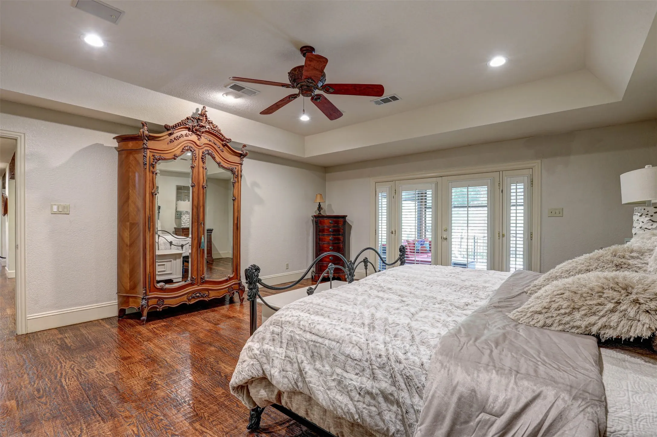 Primary bedroom showcasing the tray ceiling and generous layout.