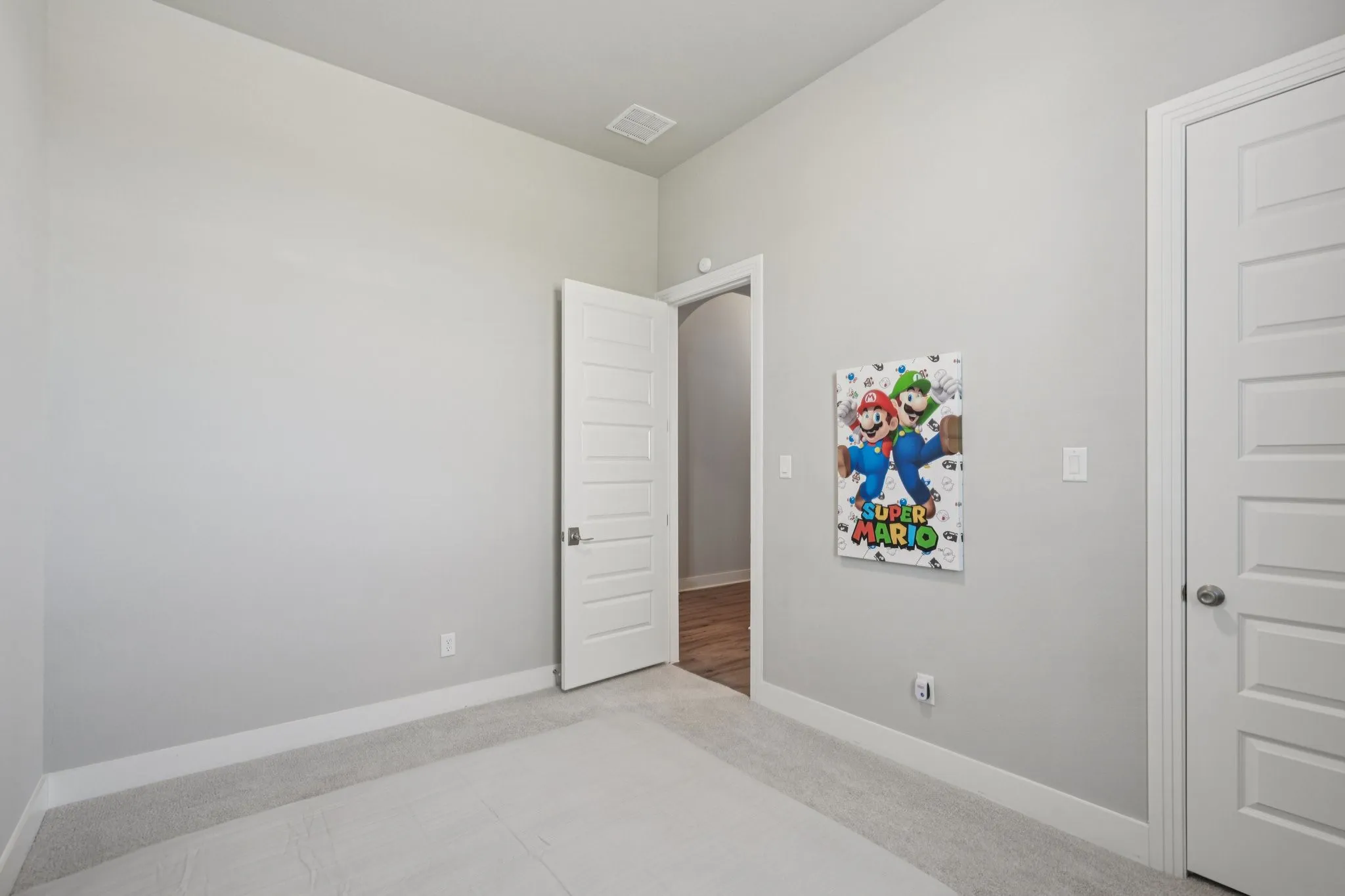 Neutral wall color, light-toned carpeting, and white trim