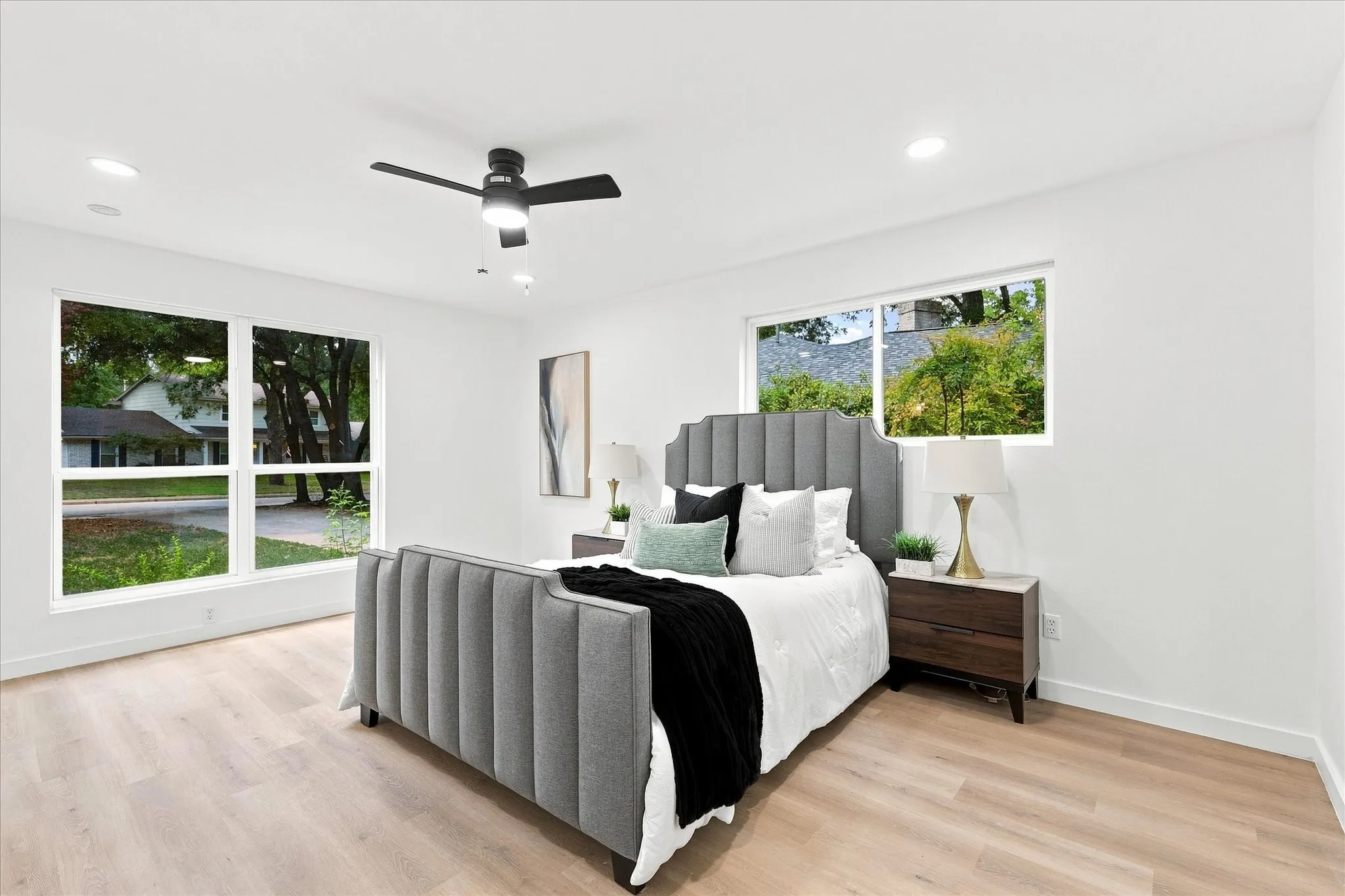 Recessed lighting, wood-finish flooring, and a contemporary ceiling fan