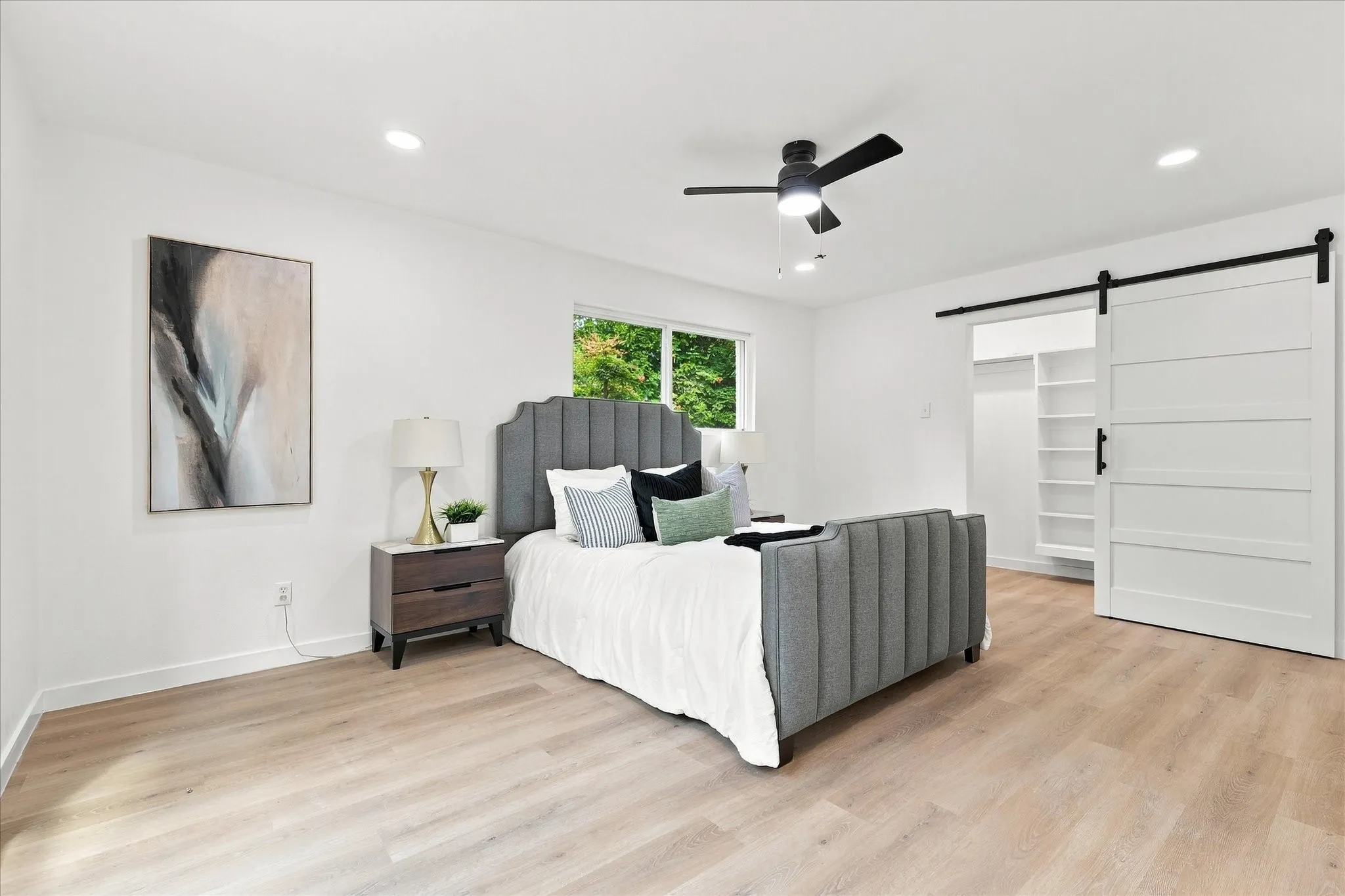 Light wood-finish flooring, recessed lighting, and a modern ceiling fan