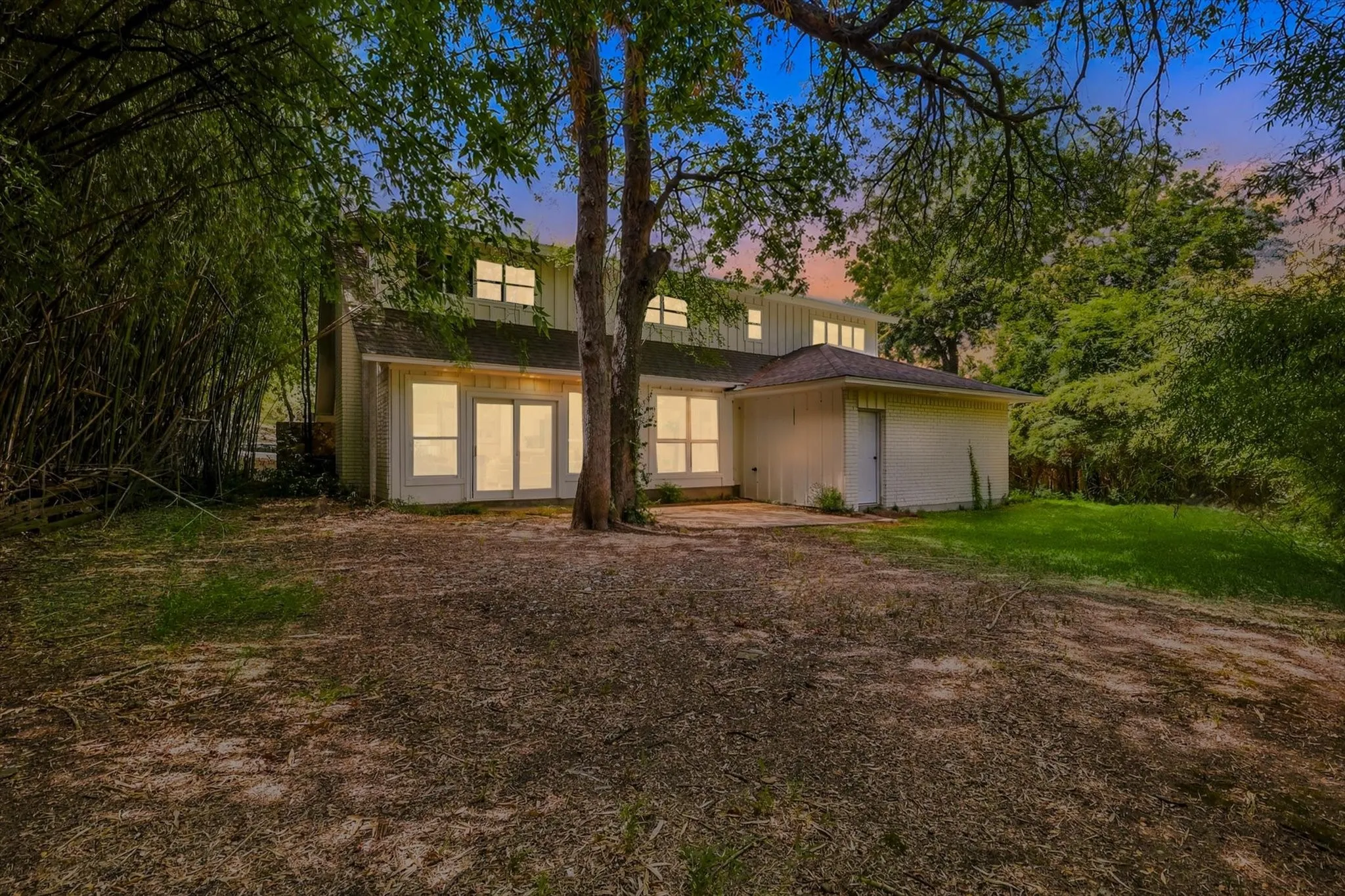 Rear elevation with multiple windows and sliding glass doors