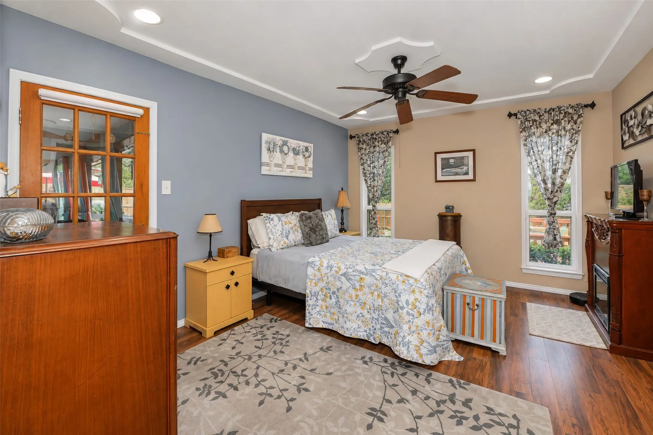 Wood-finish flooring, recessed lighting, and a ceiling fan with light fixture