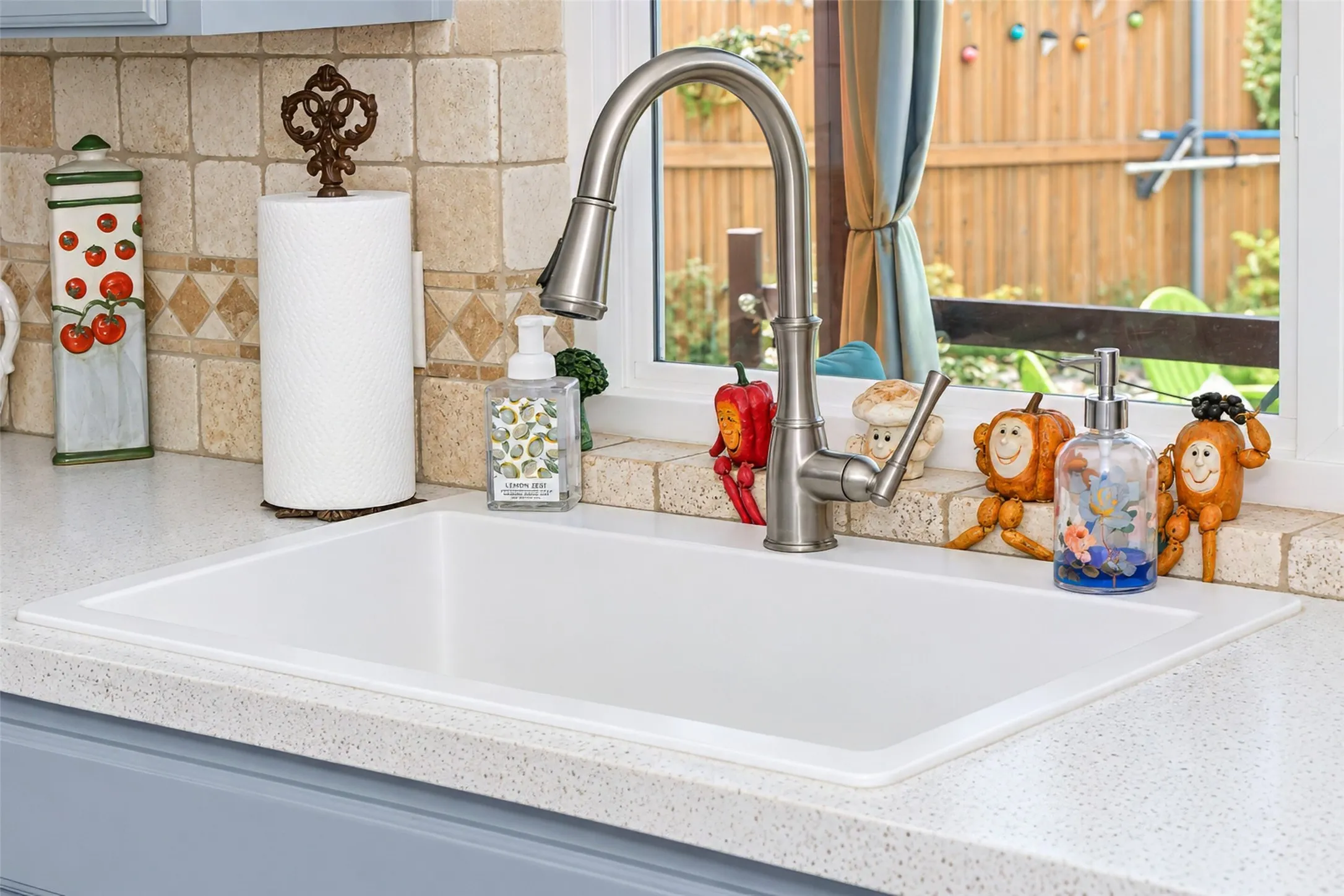 Integrated white sink with a brushed nickel gooseneck faucet, set within a light-toned speckled countertop