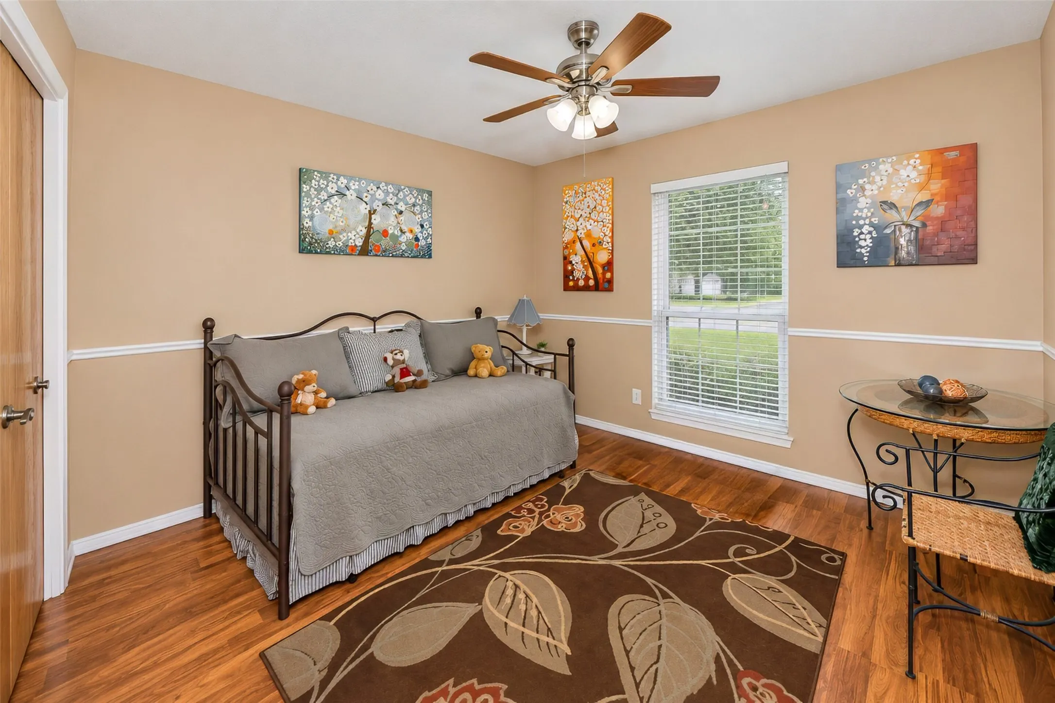 Wood-finish flooring with neutral wall paint and white trim