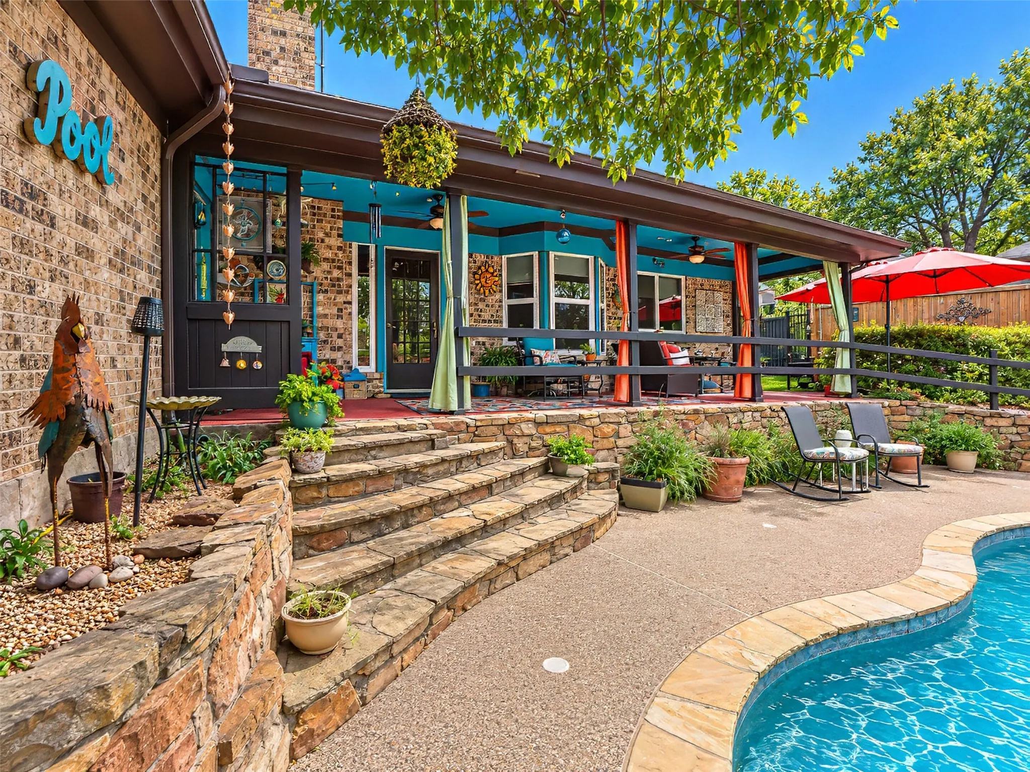 Expansive swimming pool with a curved edge and natural stone coping