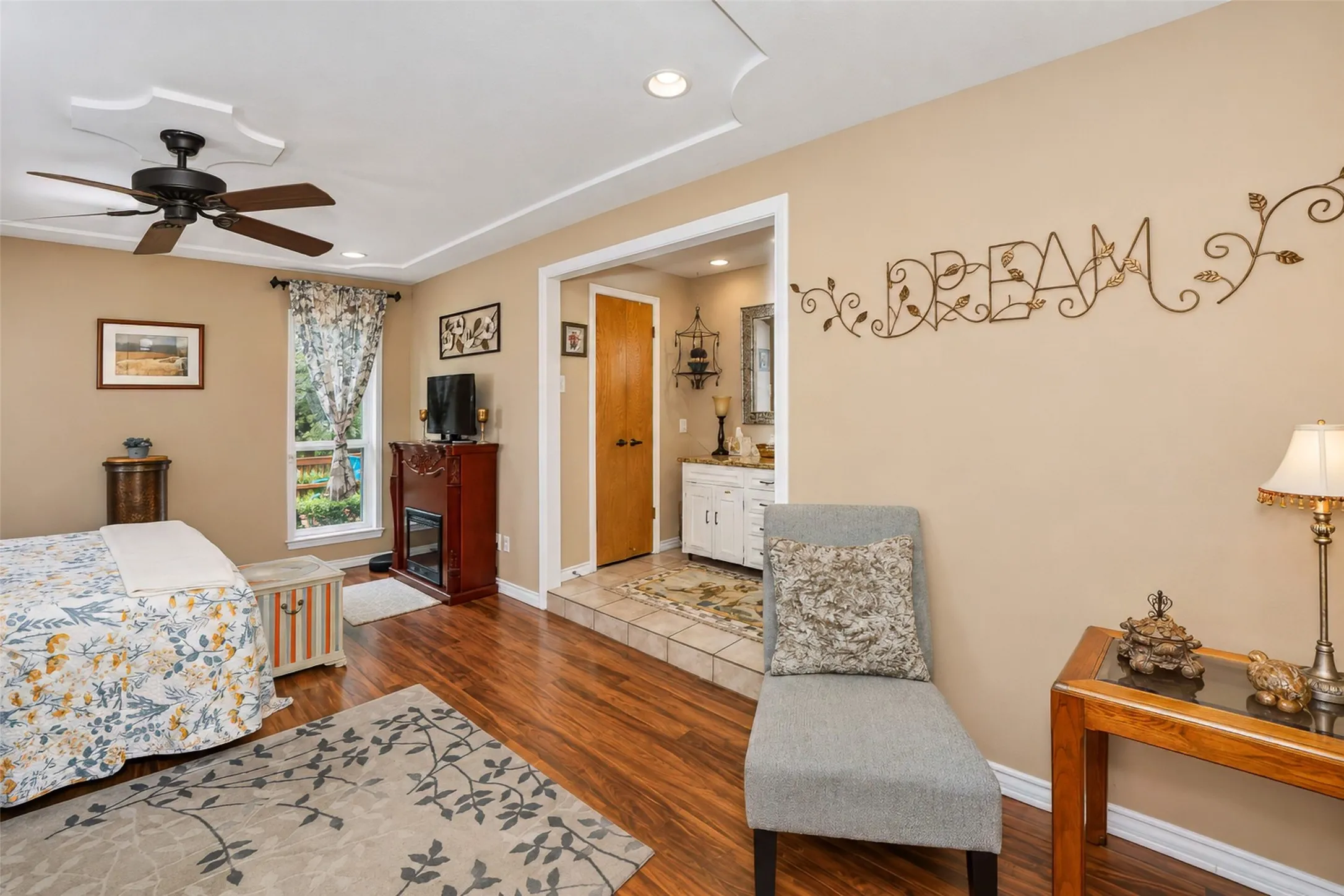 Wood-finish flooring, recessed lighting, and a ceiling fan with light fixture