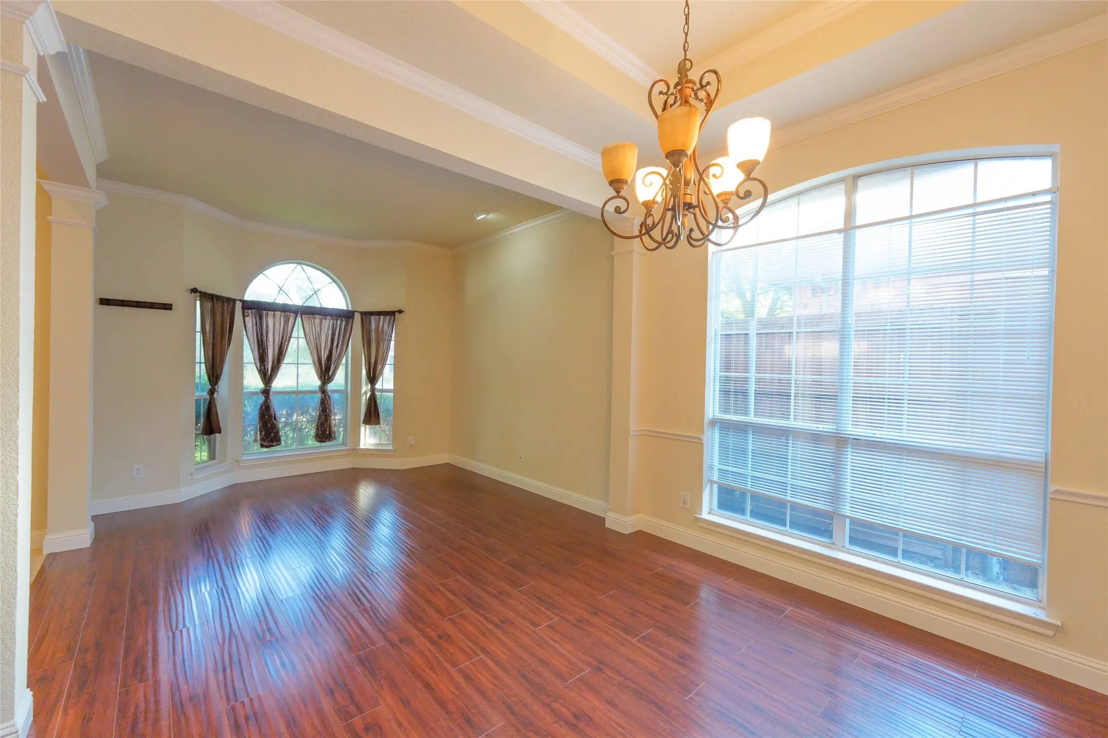 Wood-finish flooring, recessed lighting, and a decorative chandelier