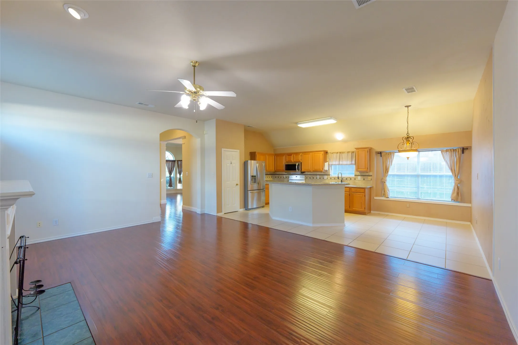 Open concept living area featuring wood-finish flooring, recessed lighting, and a ceiling fan