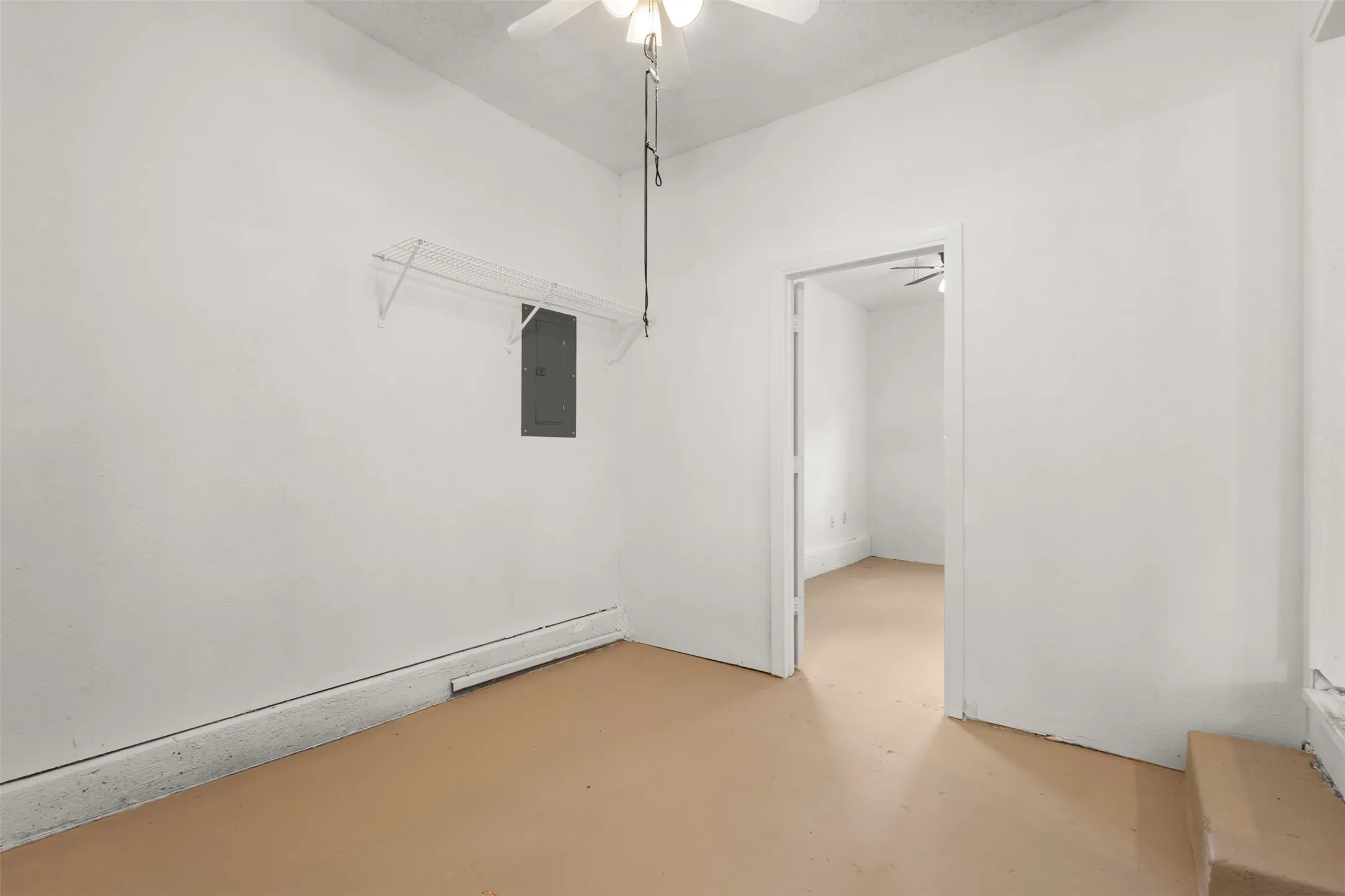 White painted walls with tan flooring