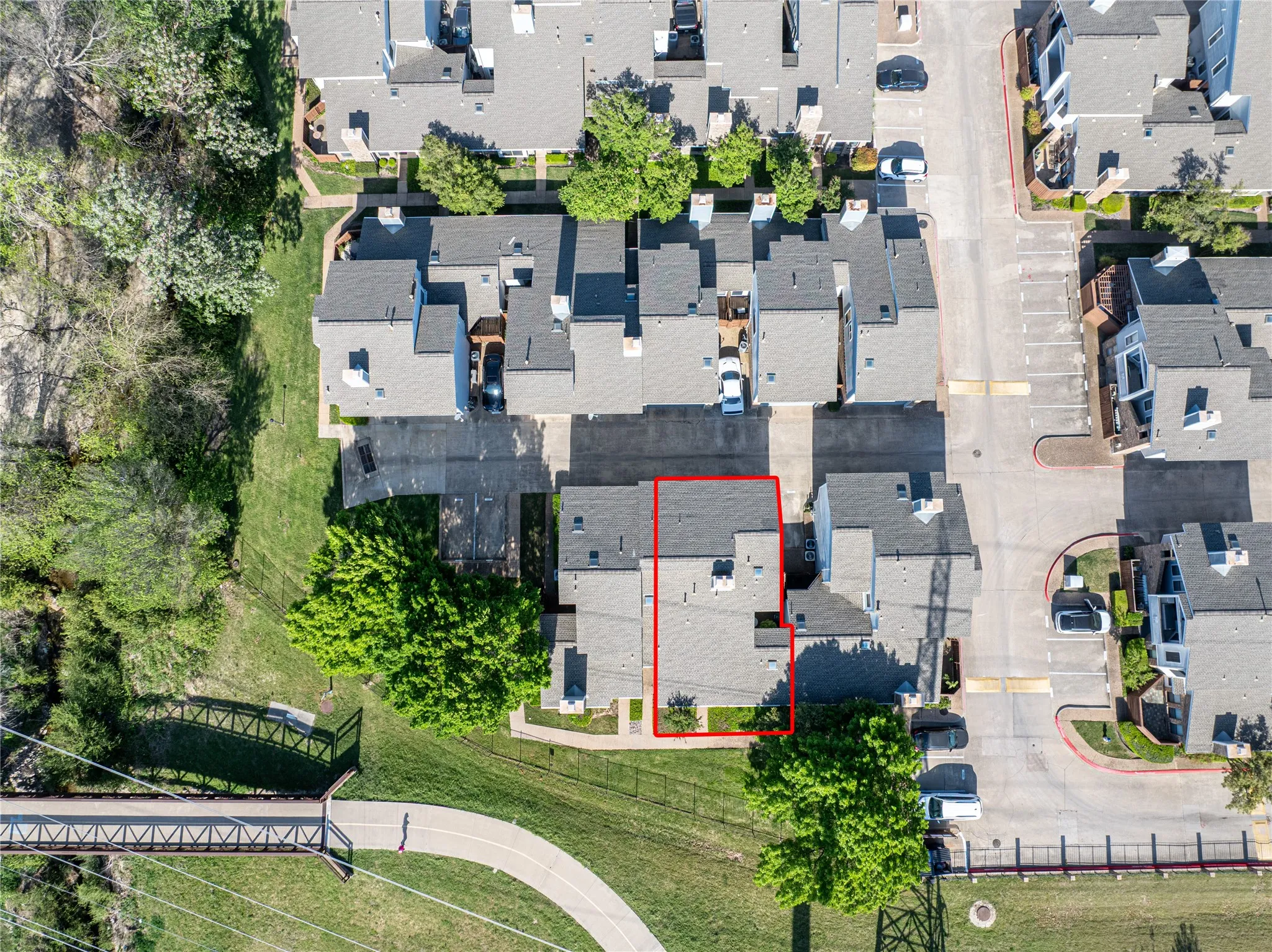 Aerial perspective showcasing the property with surrounding townhomes and a paved pathway