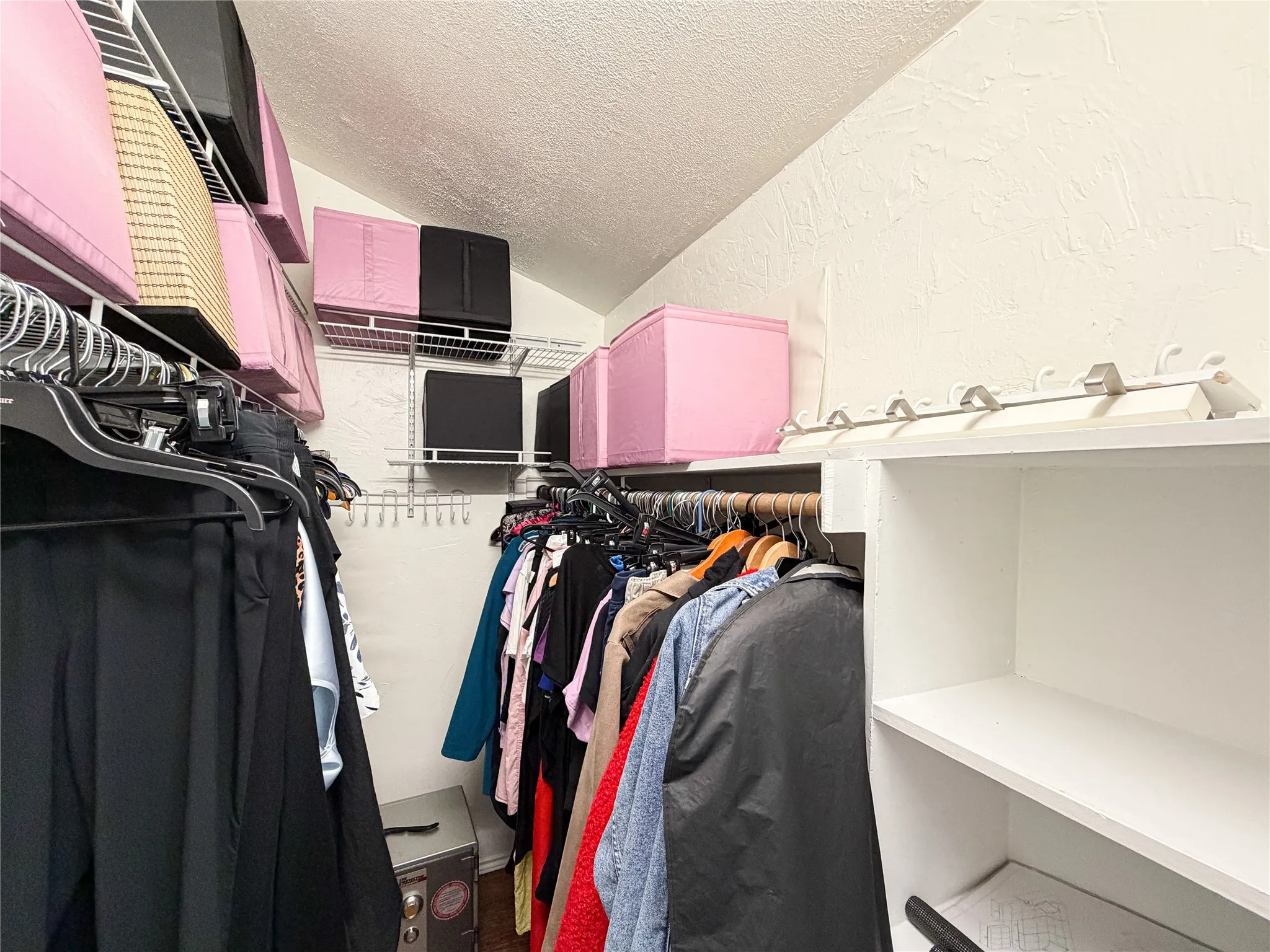 Built-in wire shelving, overhead storage, and integrated hanging rods for organization