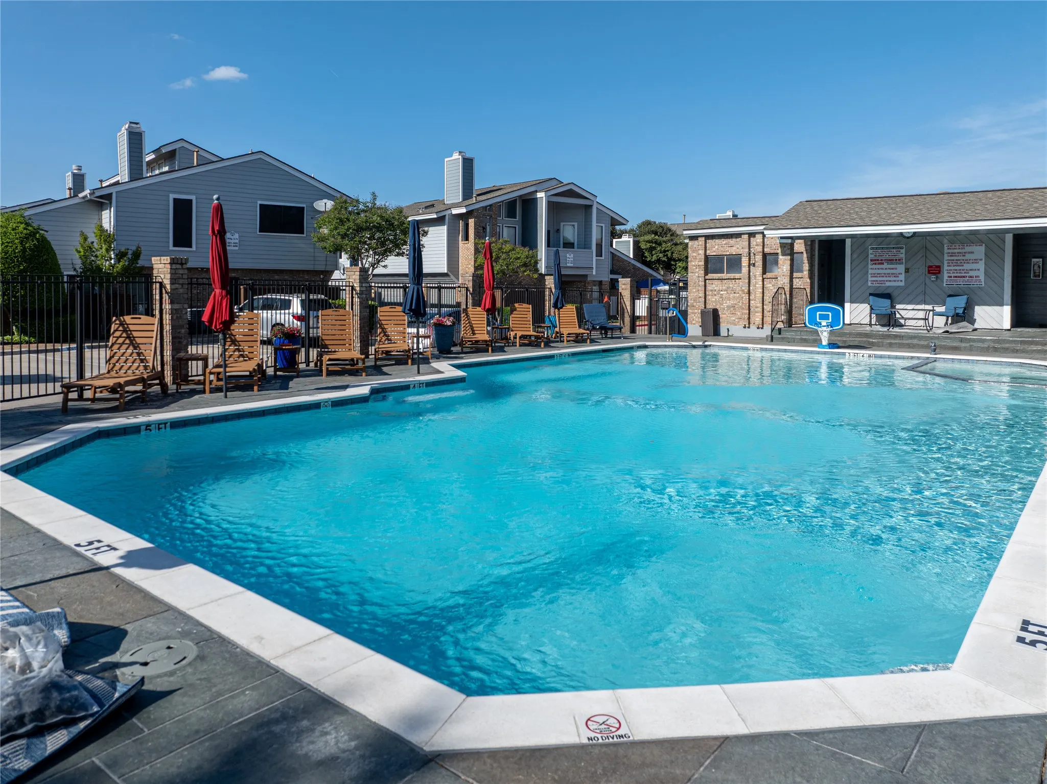 Expansive swimming pool with a surrounding perimeter fence