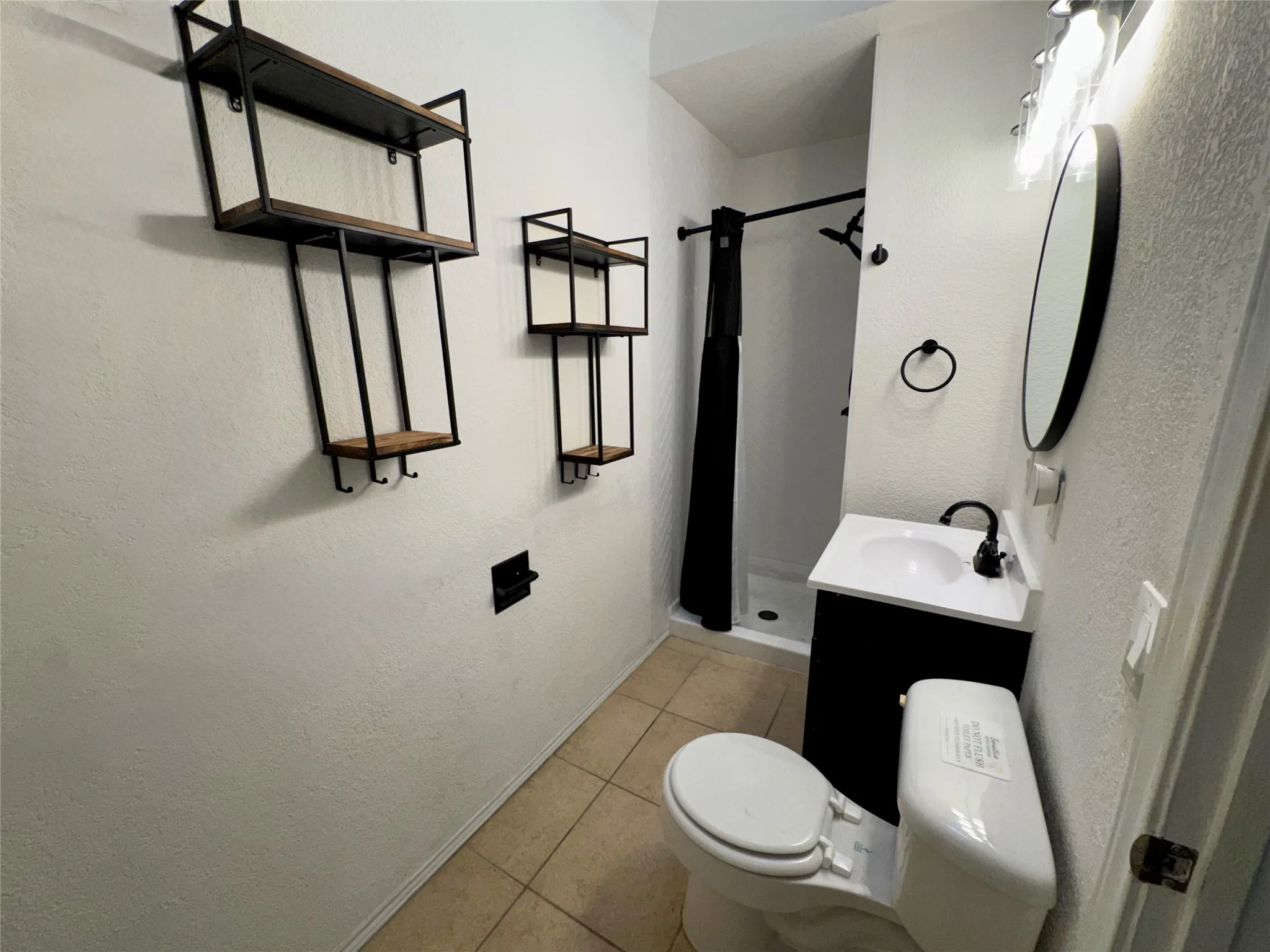 Hall bathroom located between 2 bedrooms with shower