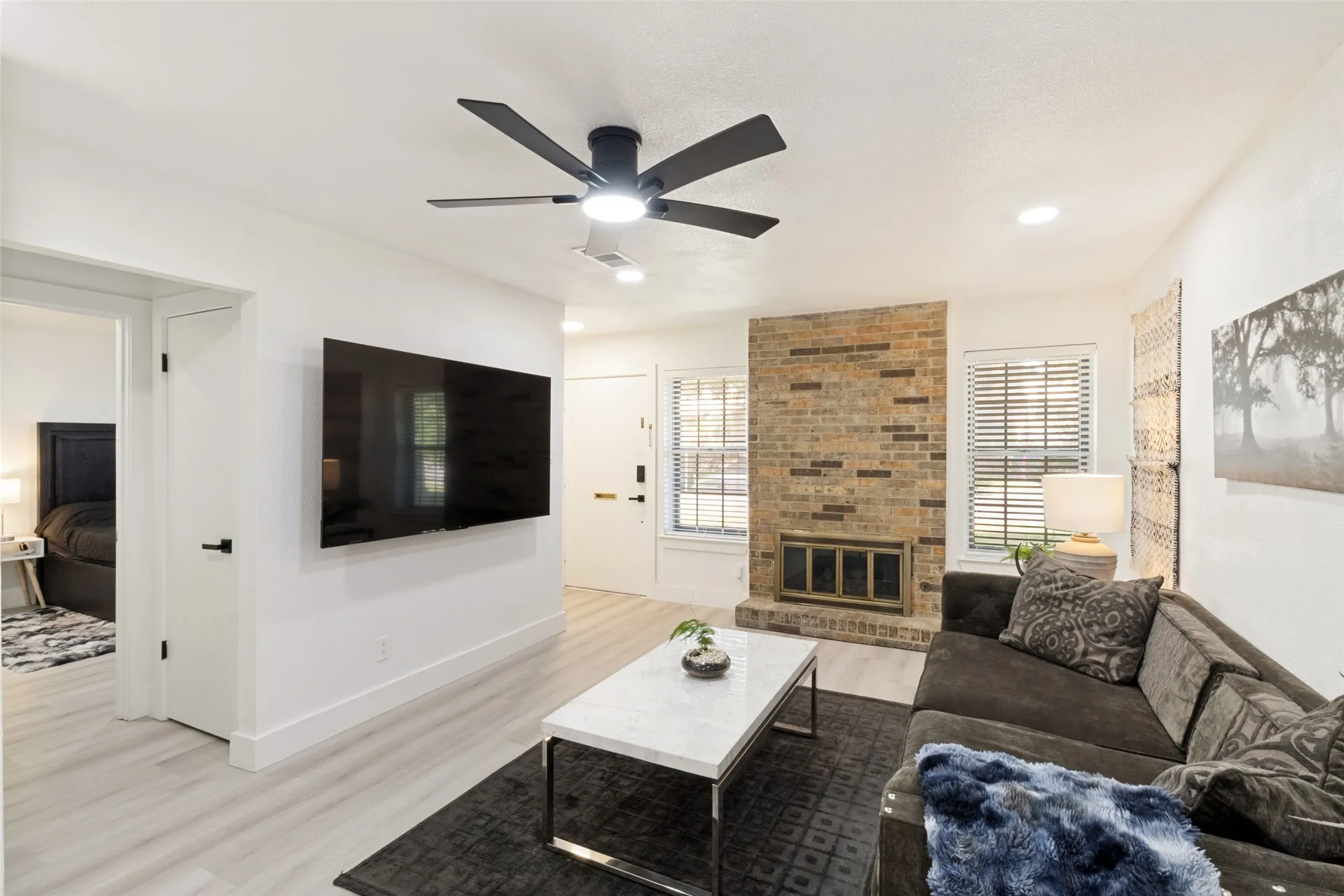 Light wood-finish flooring, recessed lighting, and a modern ceiling fan