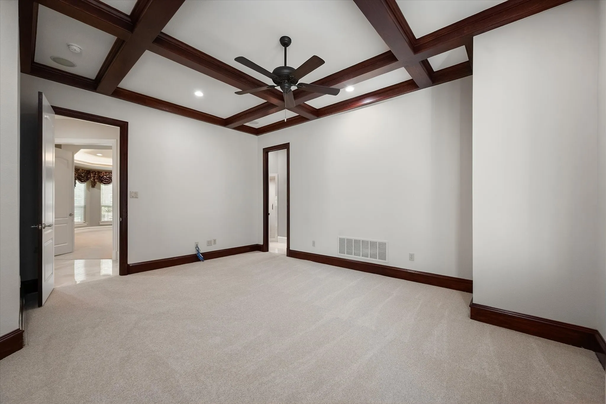 Second primary, office or library with wood-finish beams, recessed lighting, and a ceiling fan