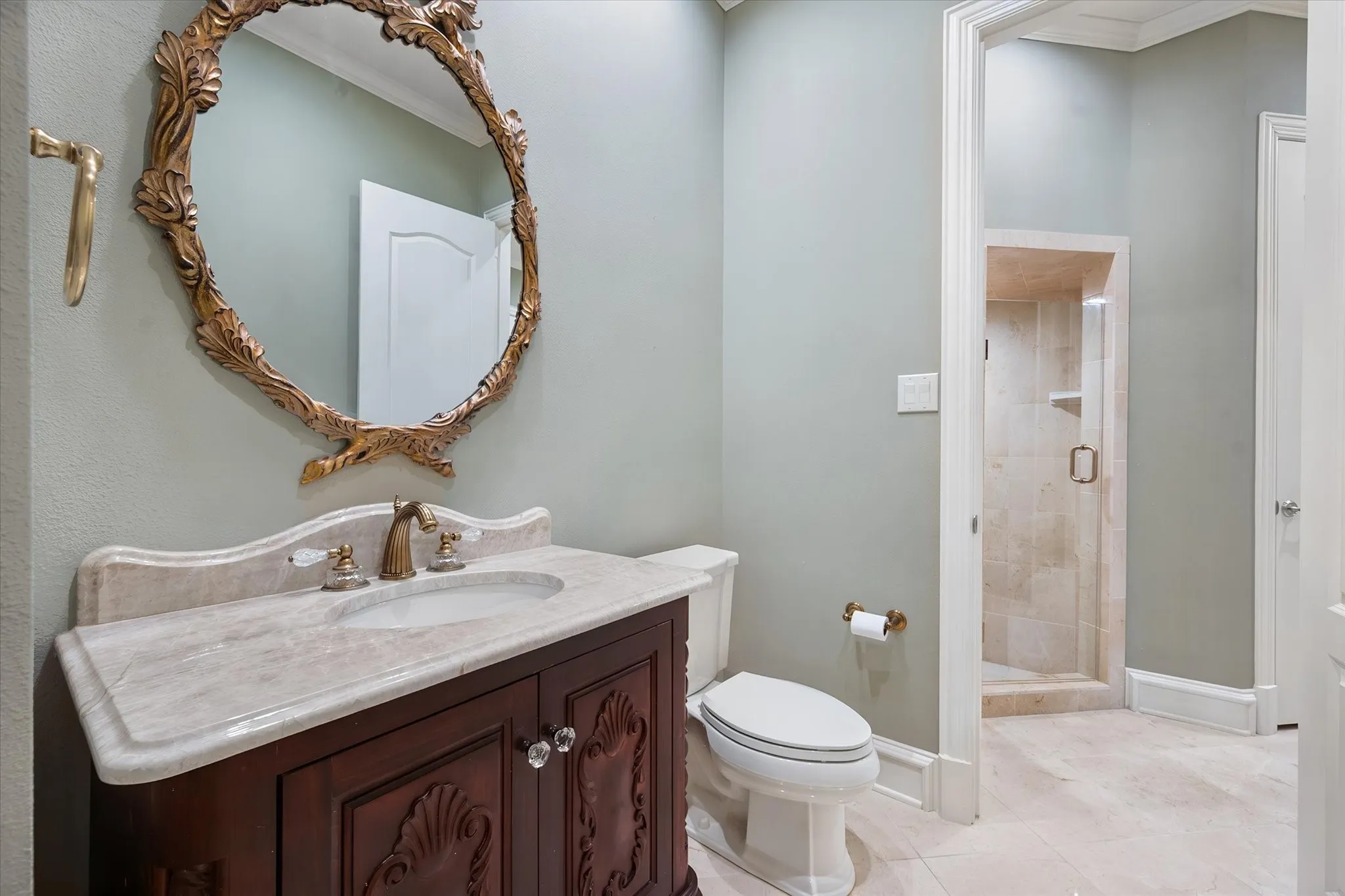 Recently updated ornate vanity with a stone countertop, new paint and an exquisite sink