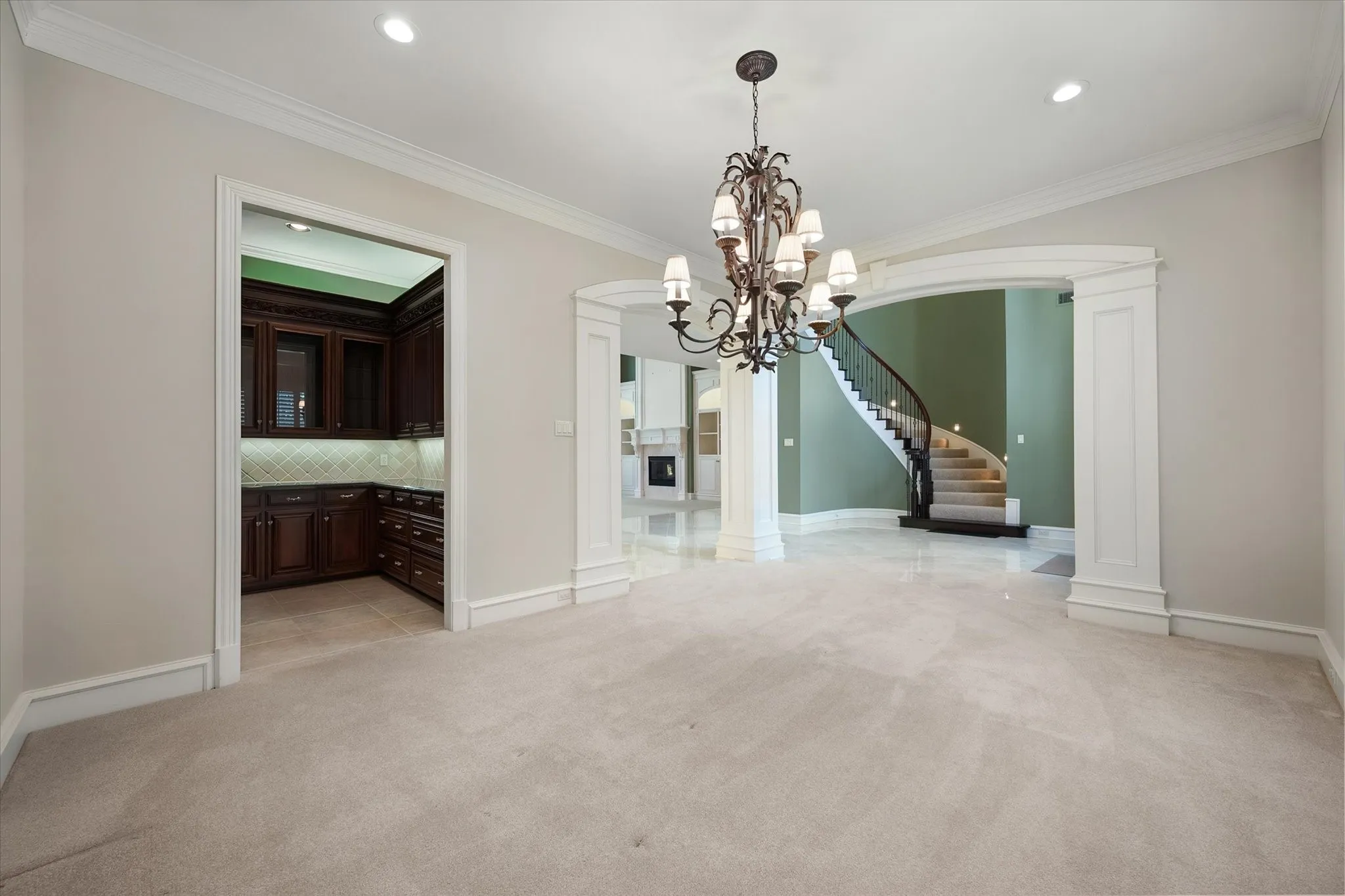 Recently painted formal dining room featuring a decorative chandelier, recessed lighting, and crown molding