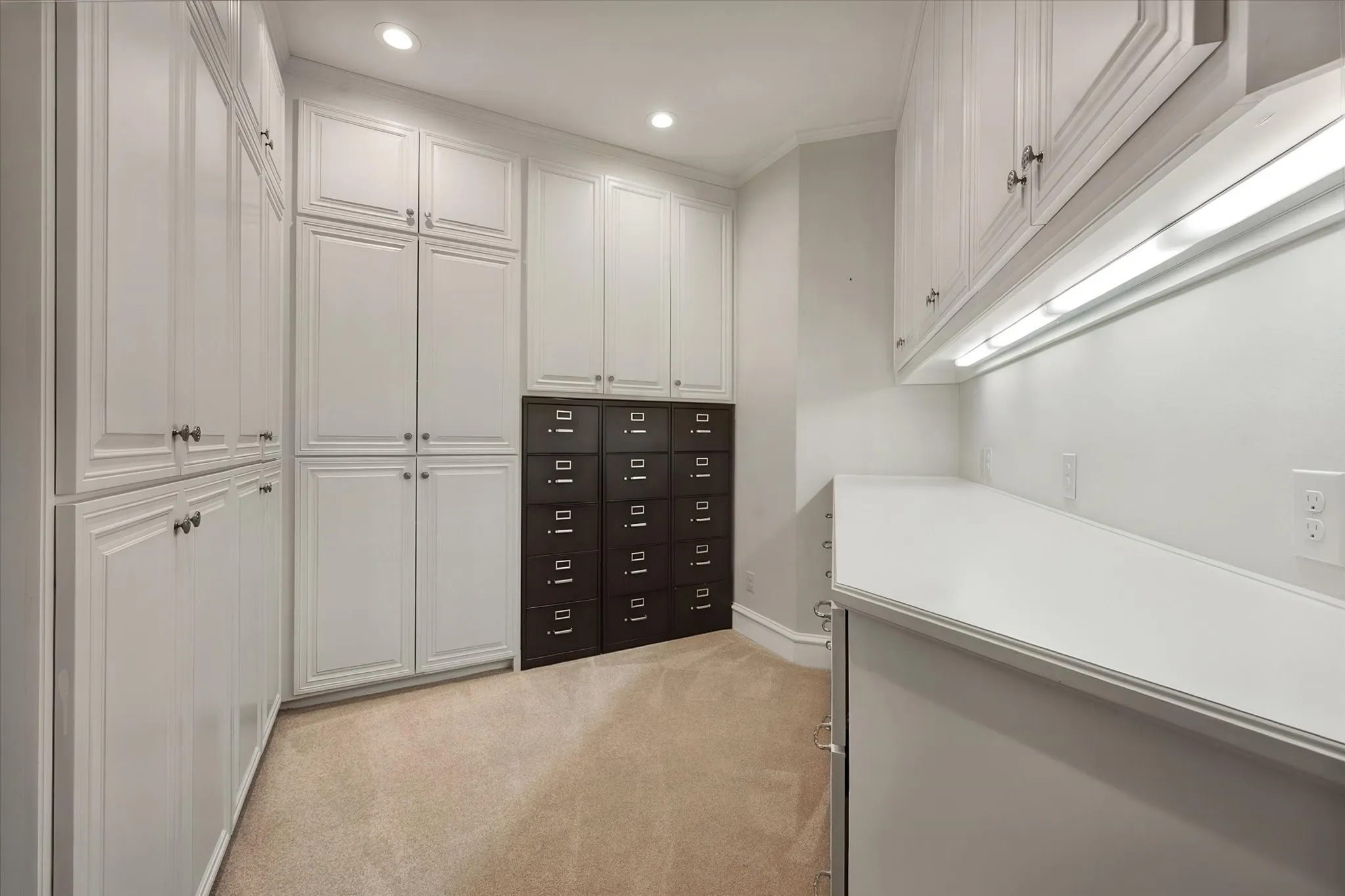 Craft or sewing room or file your important documents in this extensive storage and work area with dedicated countertop space, under-cabinet lighting, and recessed ceiling lights