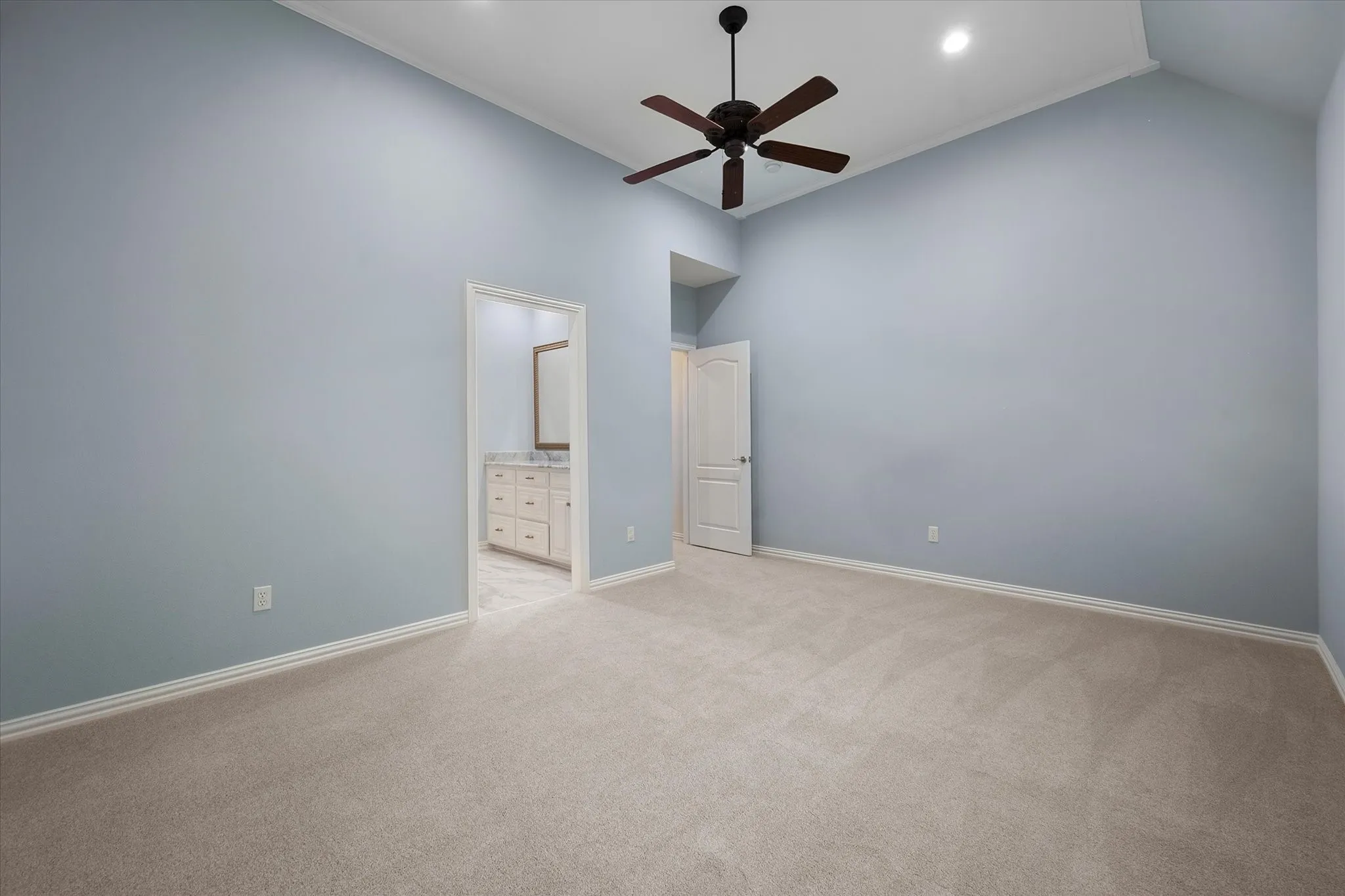 Vaulted ceiling with an installed ceiling fan, recessed lighting, and soft carpet flooring