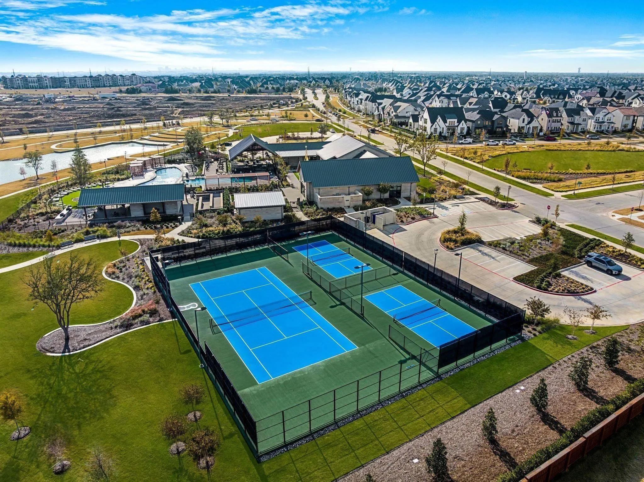 Hardcourt tennis courts, dedicated pickleball courts, and a community clubhouse with an outdoor pool