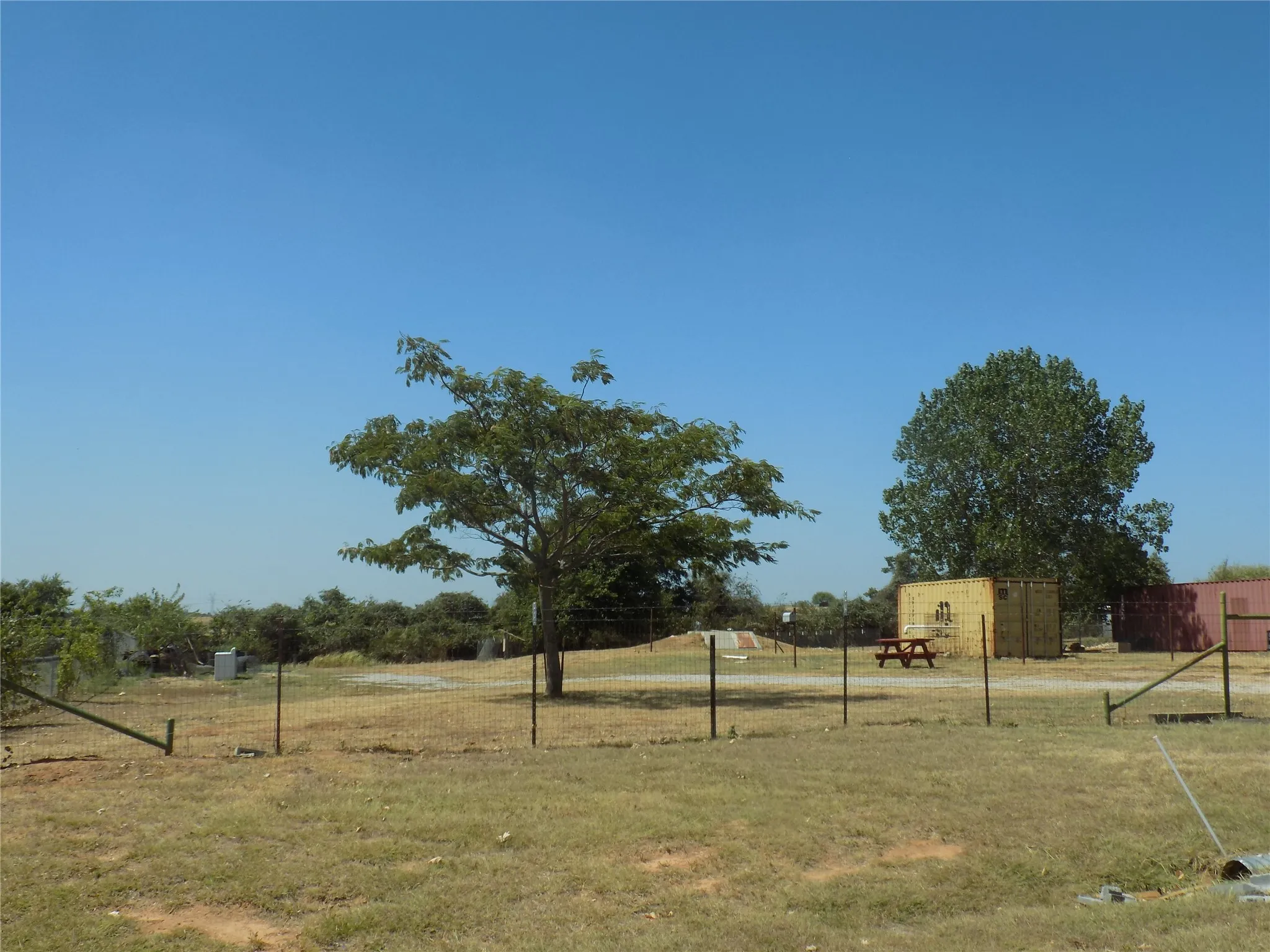 Fenced perimeter defining the property