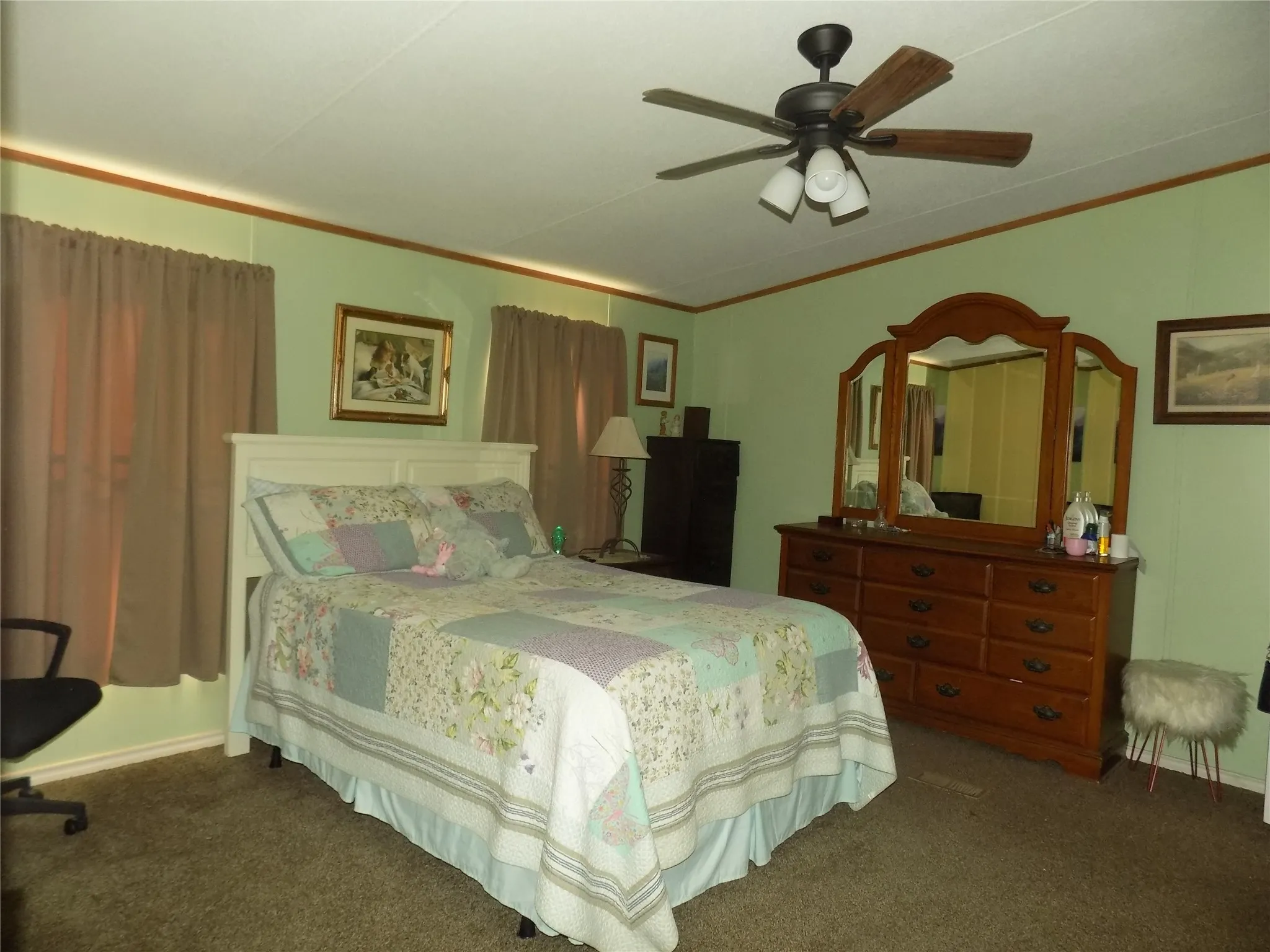 Warm, welcoming primary bedroom with en suite bathroom attached, and large walk-in closet.
