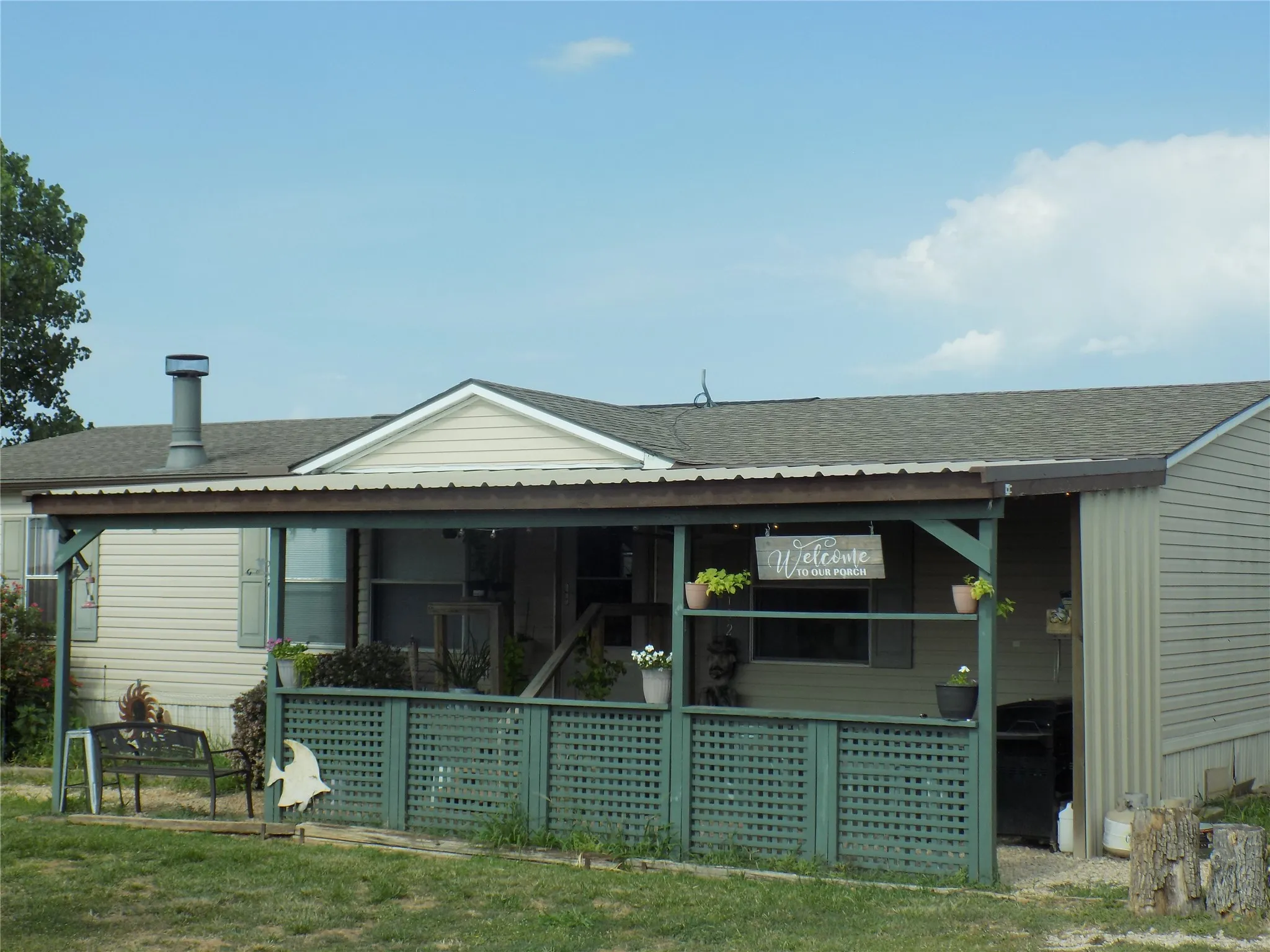 Closer view of front of home, featuring a large covered porch area.