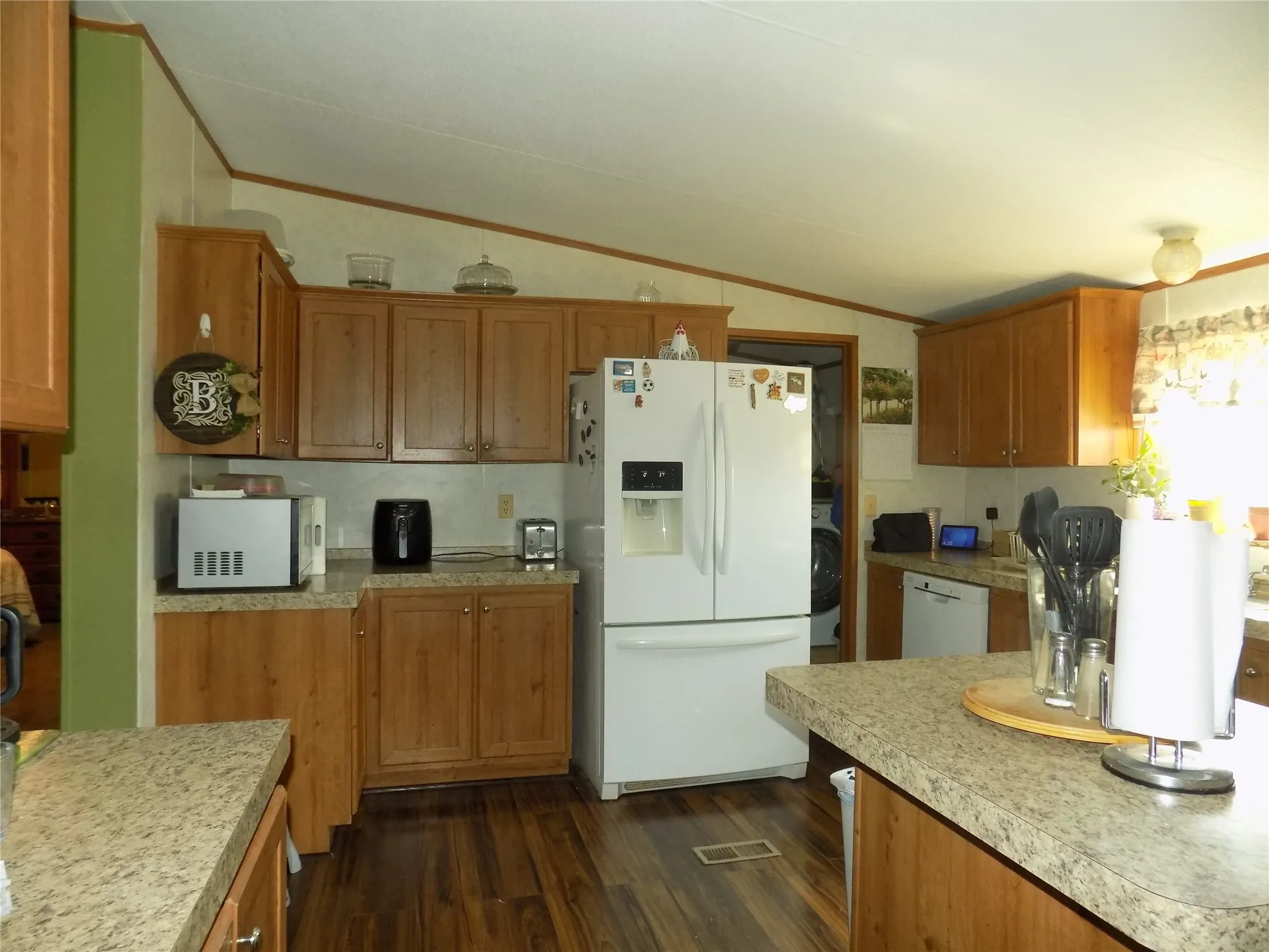 Large, open Kitchen featuring wood-finish flooring, spacious cabinetry, countertops, and kitchen island.