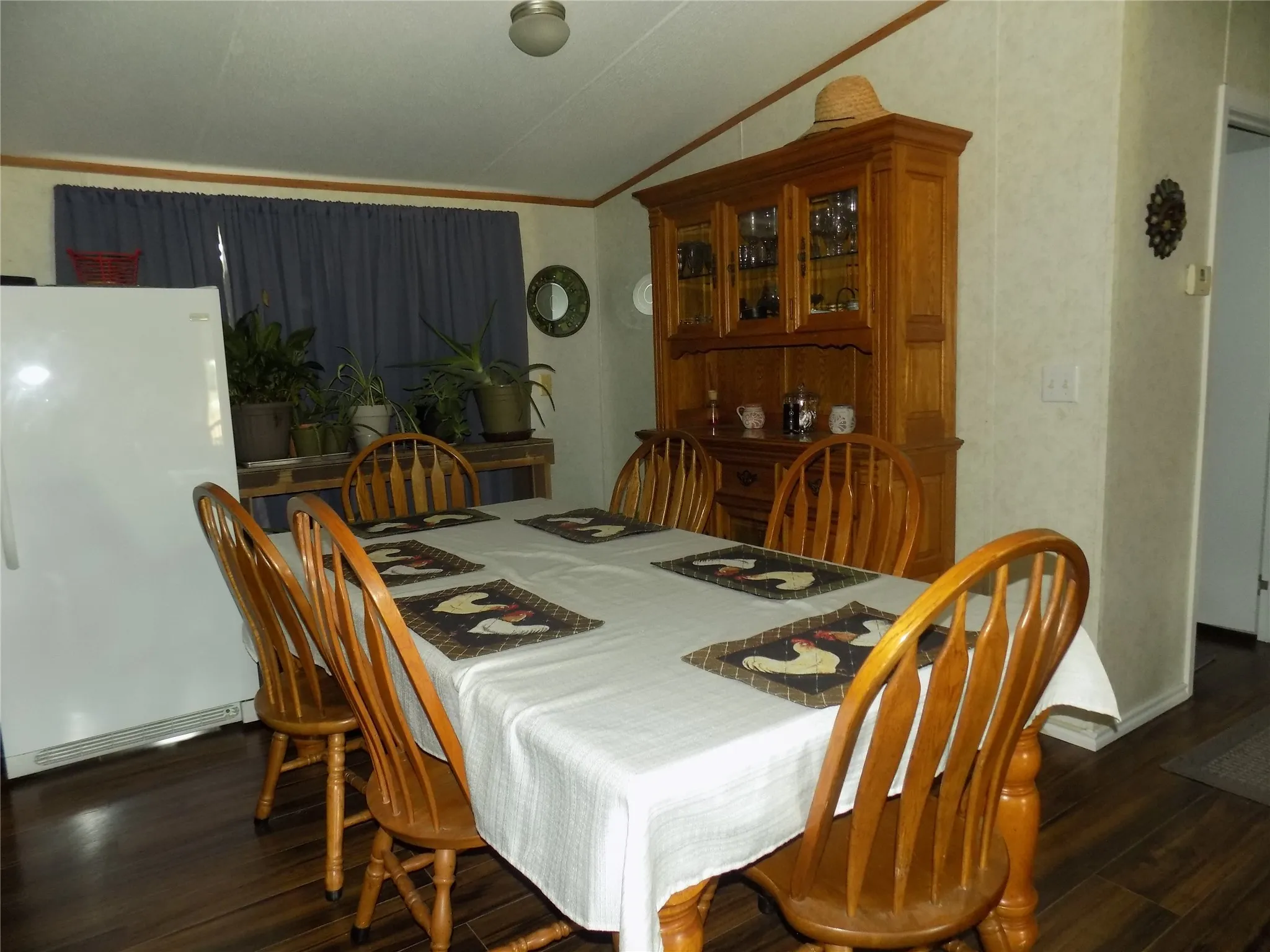 Dining area featuring wood-finish flooring, room for a china cabinet.