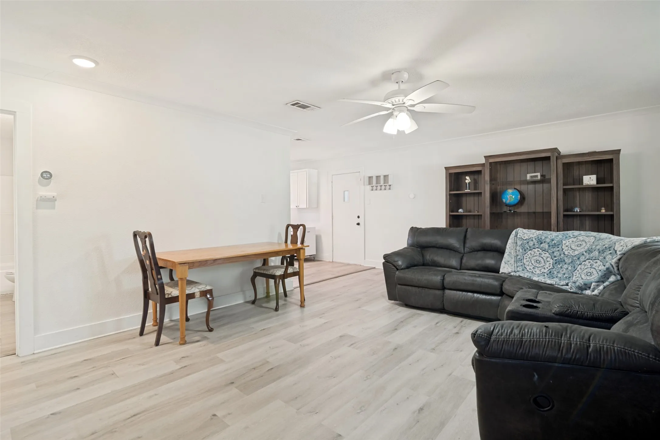 Spacious living area that is large enough for a small dining table which also features recessed lighting and a ceiling fan.