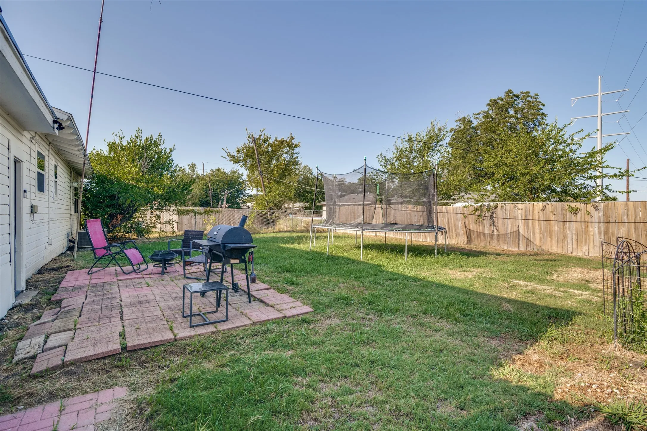 This expansive lawn area with a wood privacy fence is a perfect spot for cookouts or you morning coffee.
