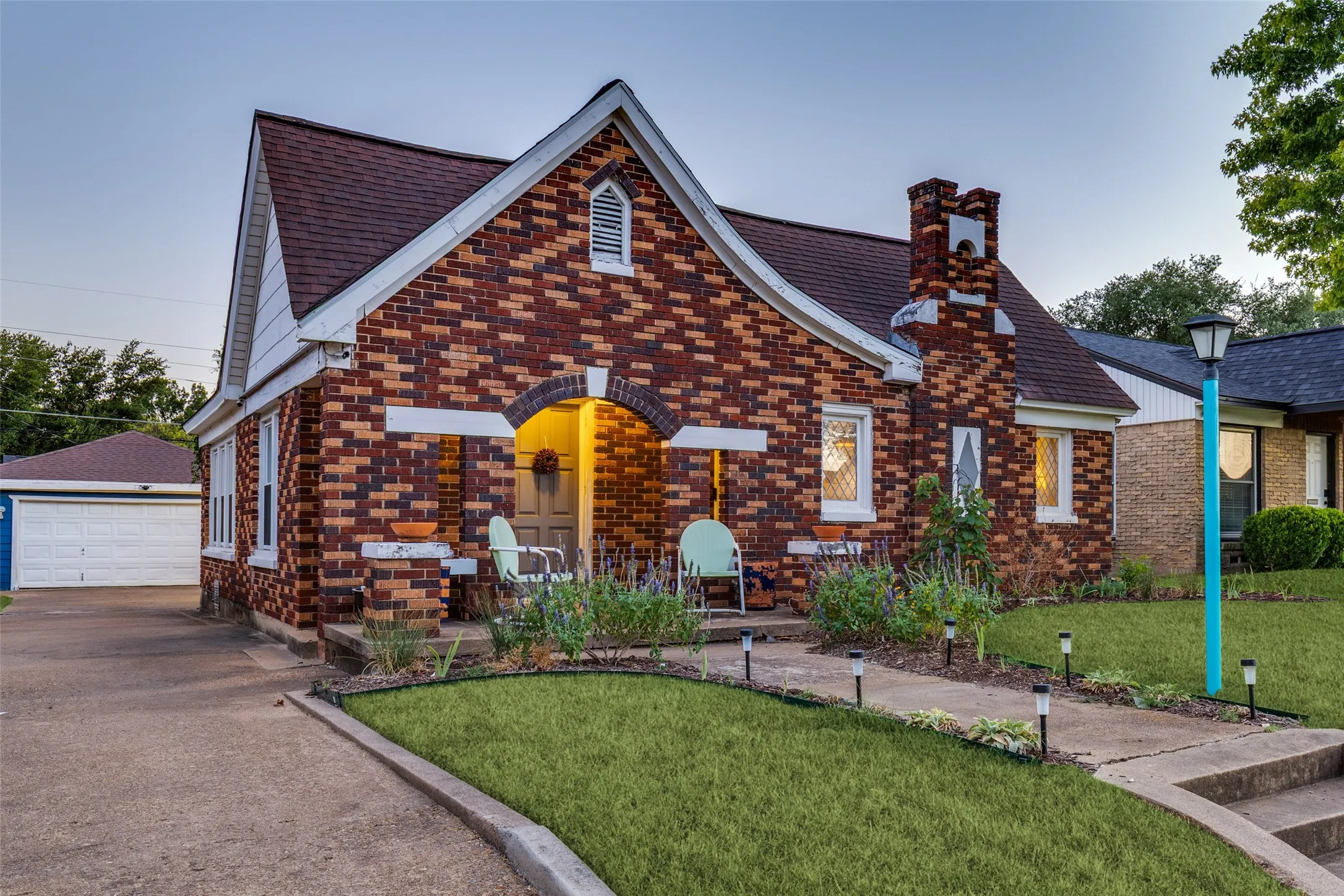 Storybook Tudor architecture makes an unforgettable first impression with distinctive brickwork, an arched entry, and inviting front porch.
