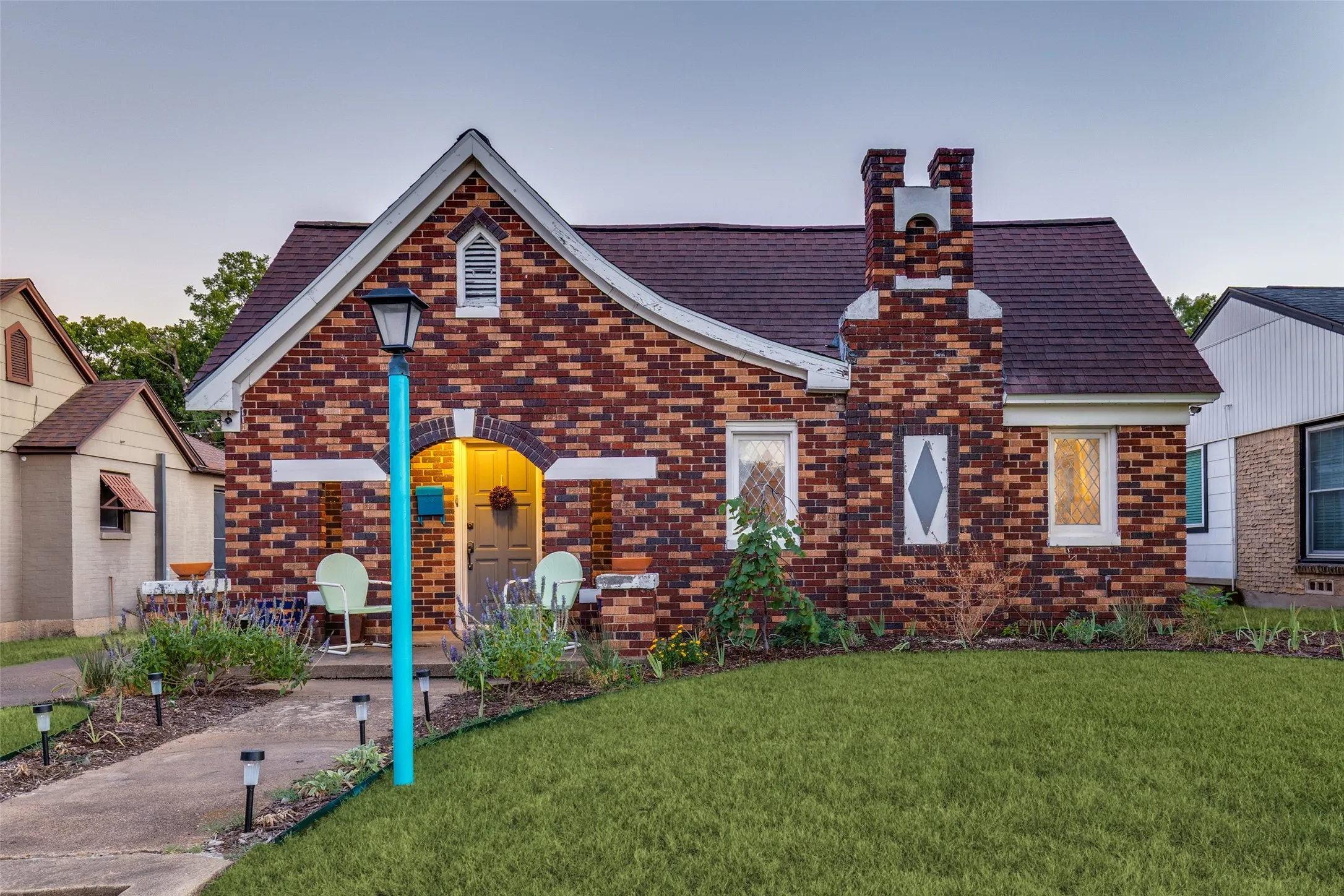 Rich brickwork, mature landscaping, and a wonderfully whimsical façade give this classic home undeniable curb appeal.
