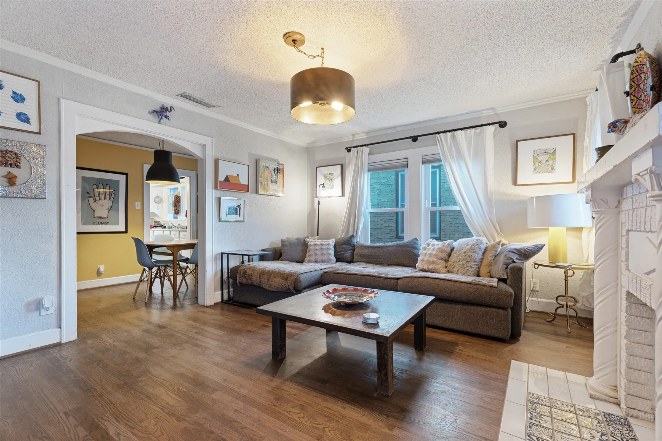 A graceful arched opening creates an easy flow from the Living Room into the Dining Room while preserving the home's original floor plan.
