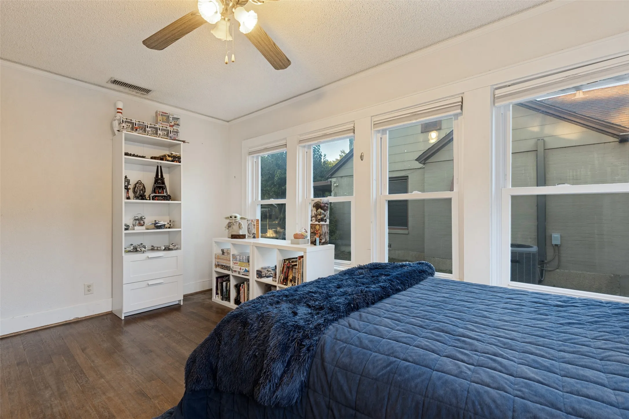 Multiple exposures fill Bedroom 1 with light and give the space an airy, relaxed mood.