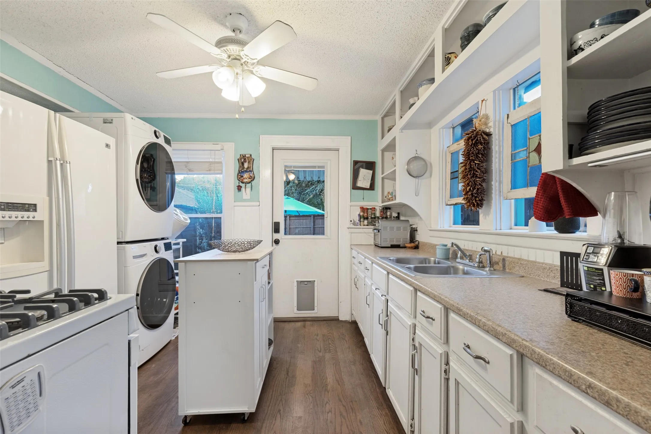 A rear Kitchen door provides direct access to the patio and backyard for effortless indoor-outdoor living.
