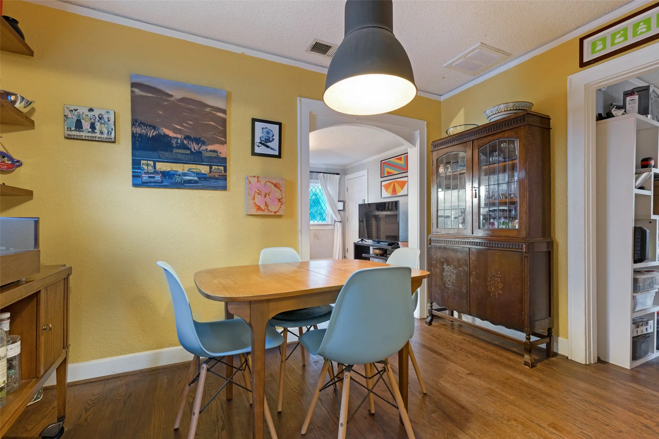 The Dining Room brings a warm, funky vibe with hardwood floors, bold color, and plenty of personality.
