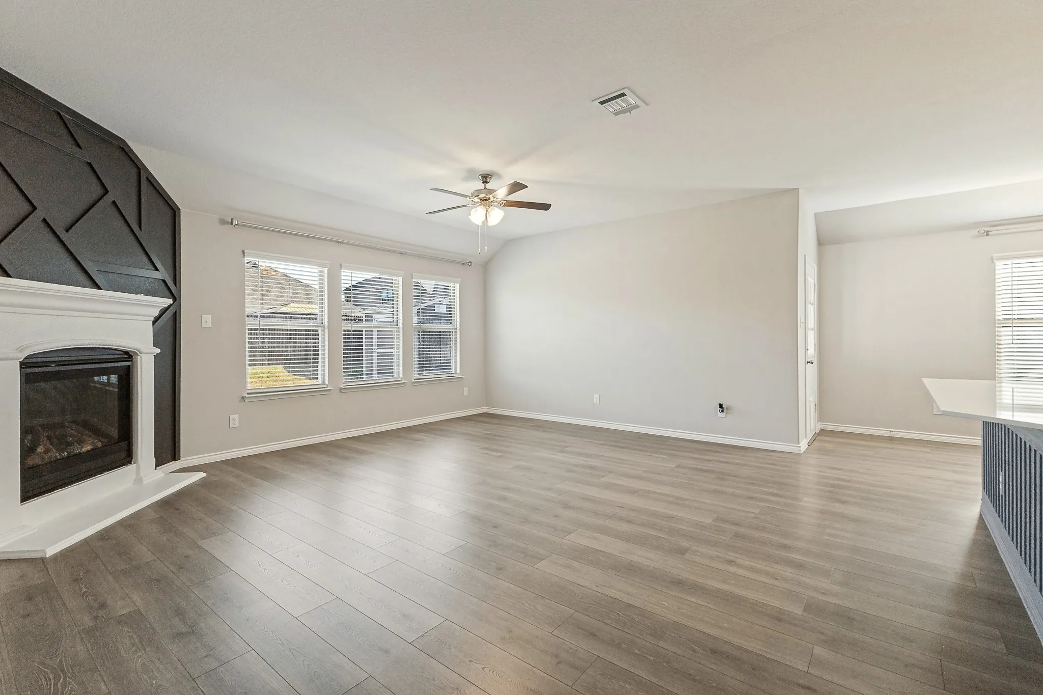 Family Room with Gas Log Fireplace and Lux Vinyl Flooring.