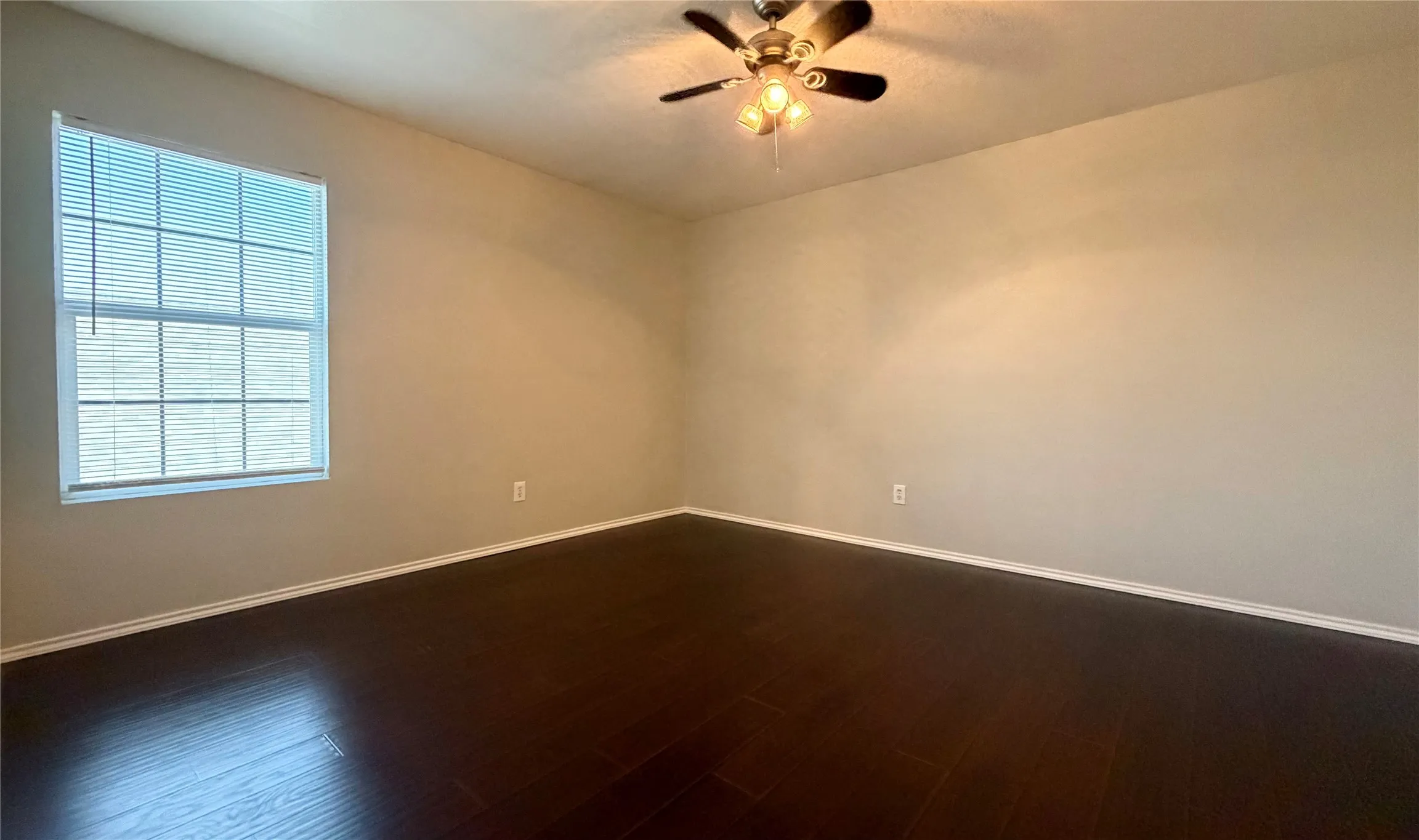 2nd bedroom upstairs featuring wood-finish flooring, a large window with blinds, and a ceiling fan with integrated lighting