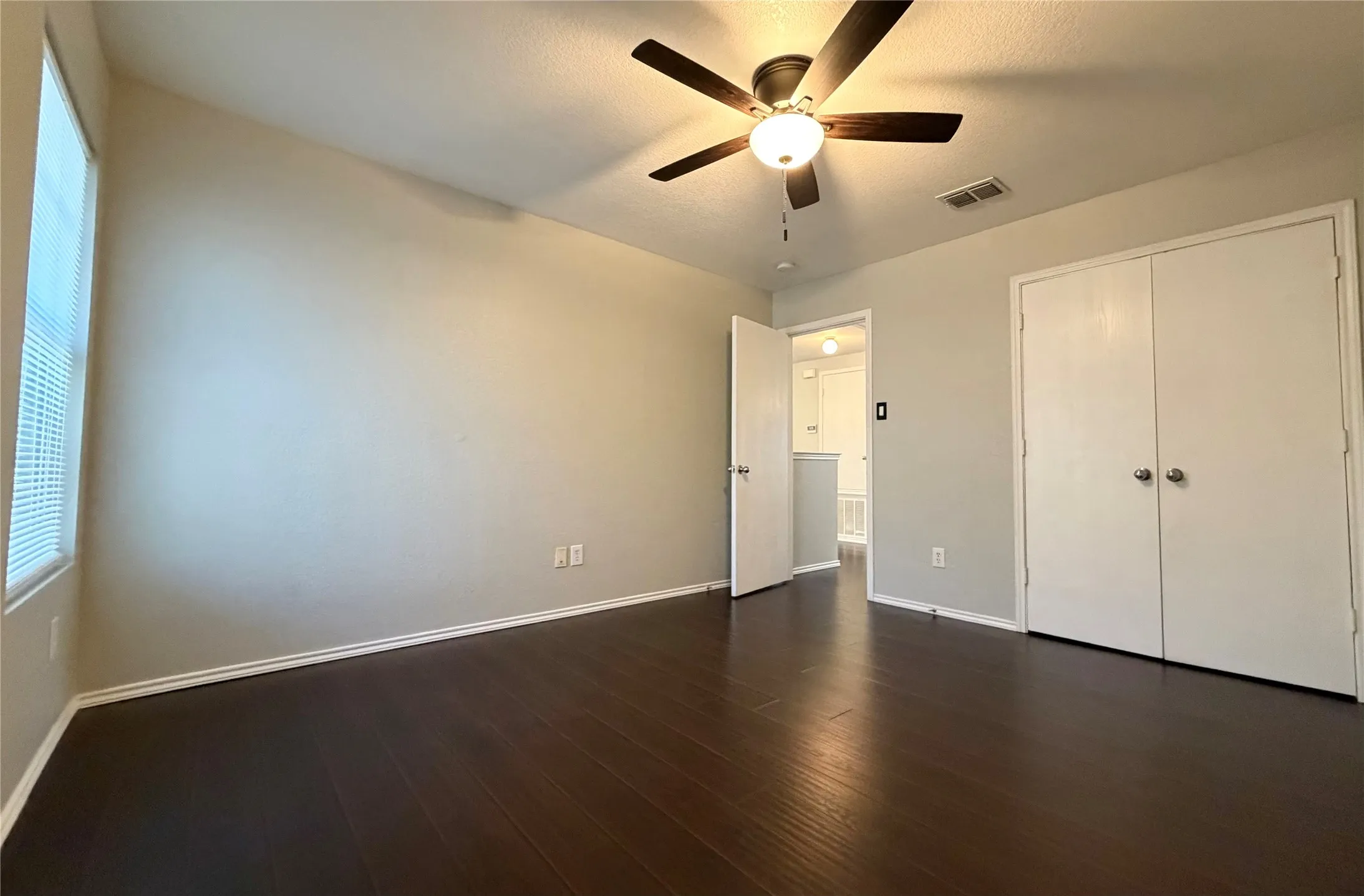 Dark wood-finish flooring with light-toned walls