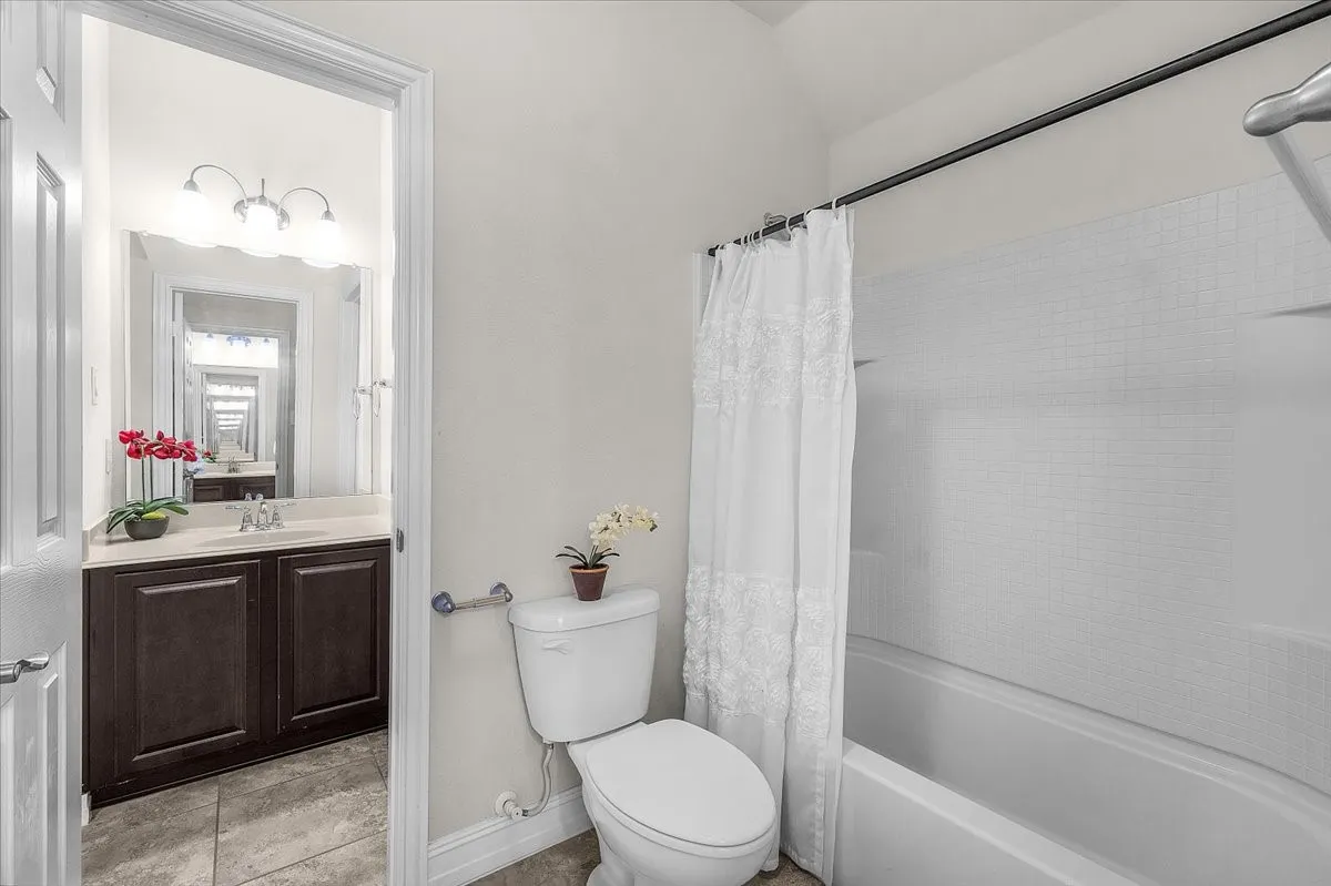 White-tiled shower surround with an integrated tub