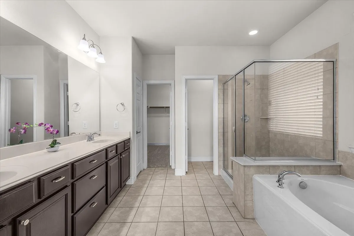 Dual vanity with dark wood-finish cabinetry and light-toned countertops