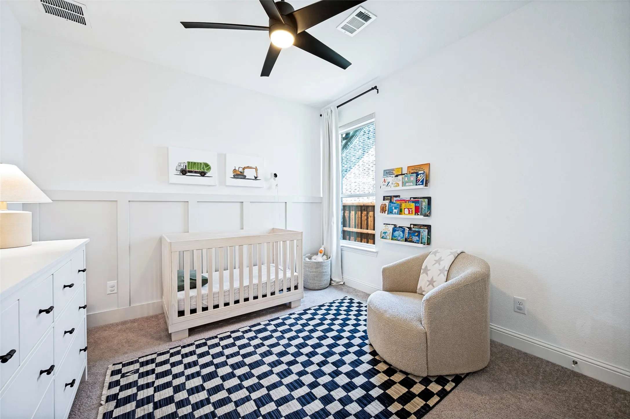 White walls with wainscoting paneling, a ceiling fan with integrated lighting, recessed window, and wall-mounted shelving