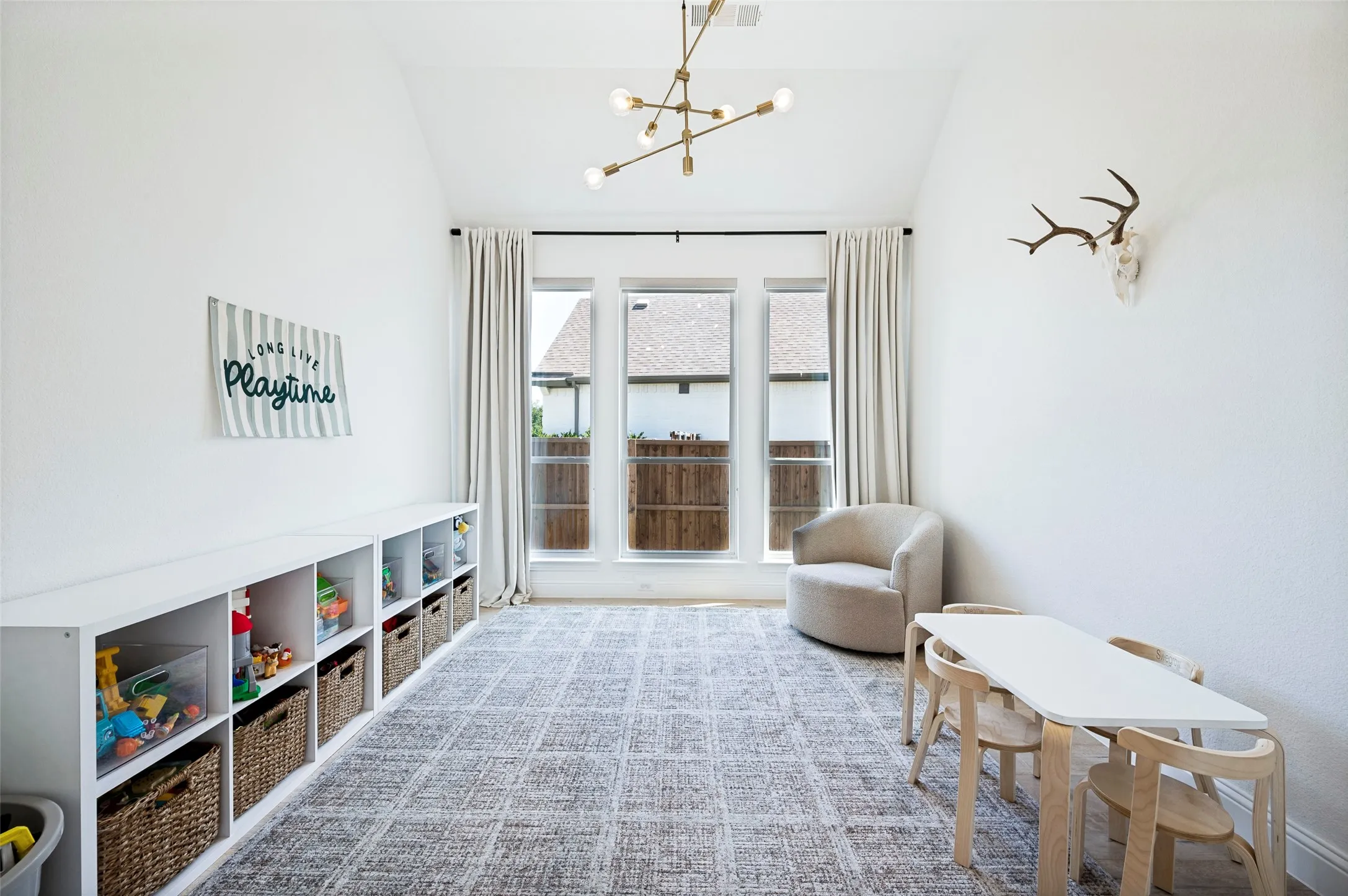 Vaulted white ceilings with a modern brass chandelier