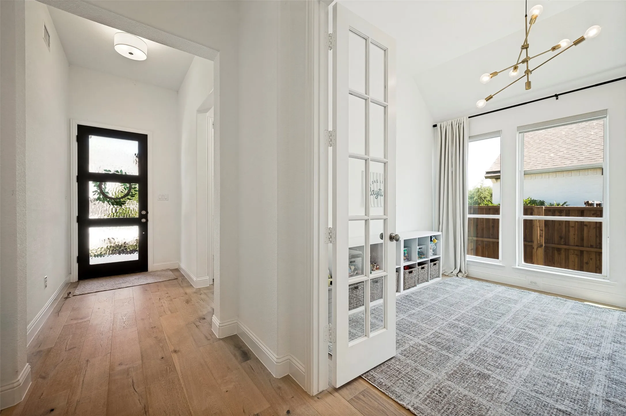 Flex space located off of the main entry way with French doors providing privacy from main living space