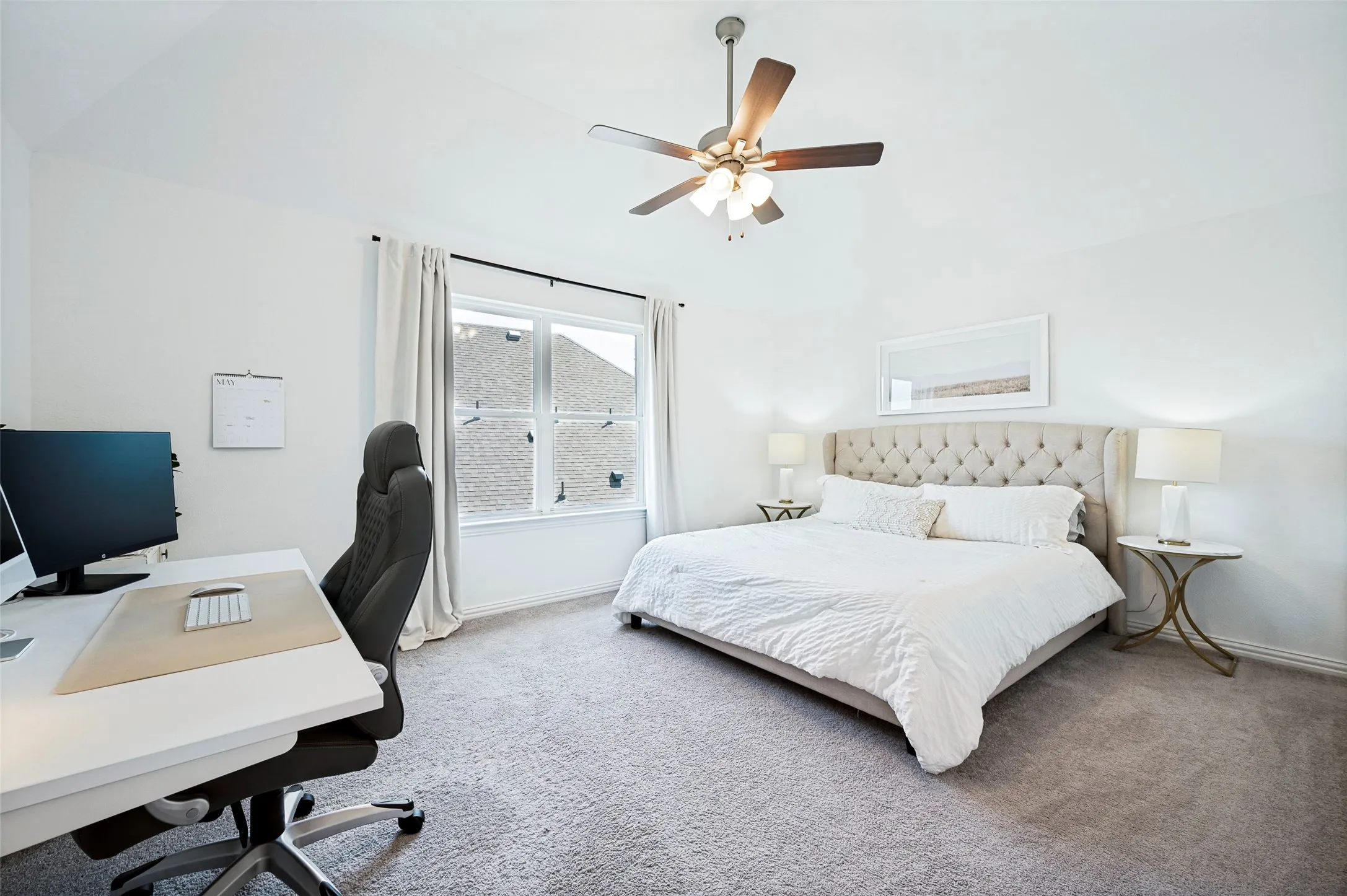 Carpeted flooring, vaulted ceiling, and a ceiling fan with integrated lighting