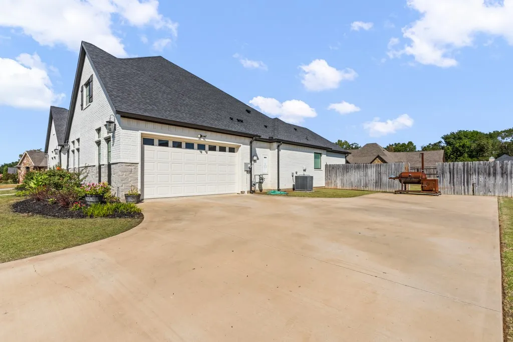 White brick exterior with a dark shingle roof