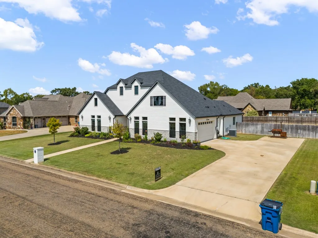 Modern white siding exterior with dark gray roofing